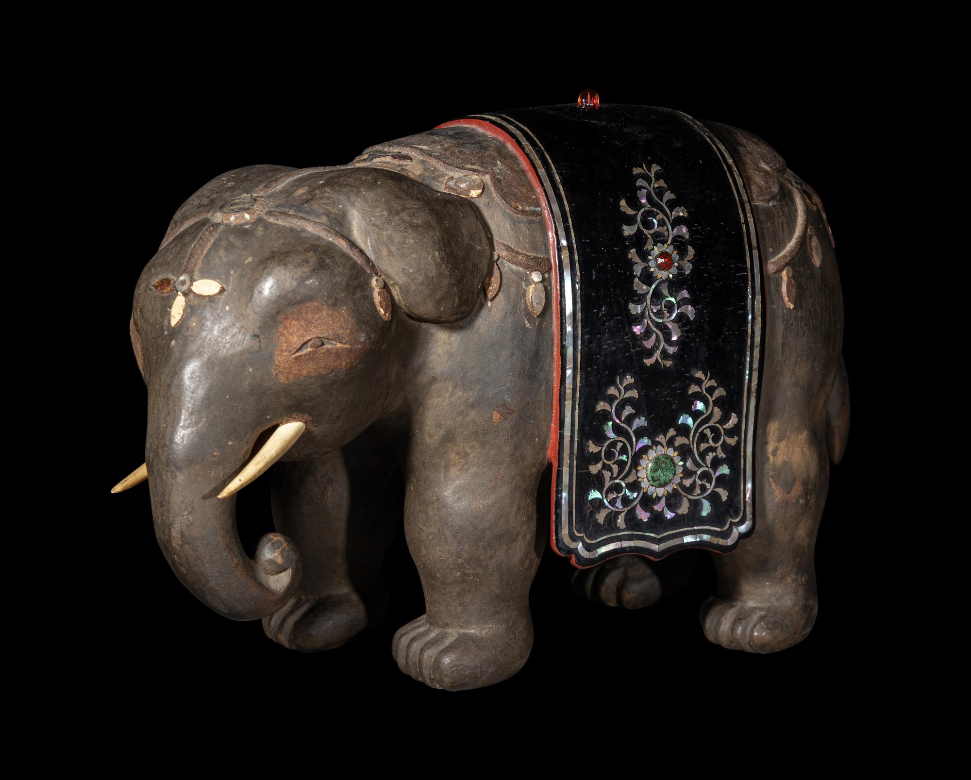 A Japanese Mother-of-Pearl Inlaid Lacquered Wood Okimono of an Elephant