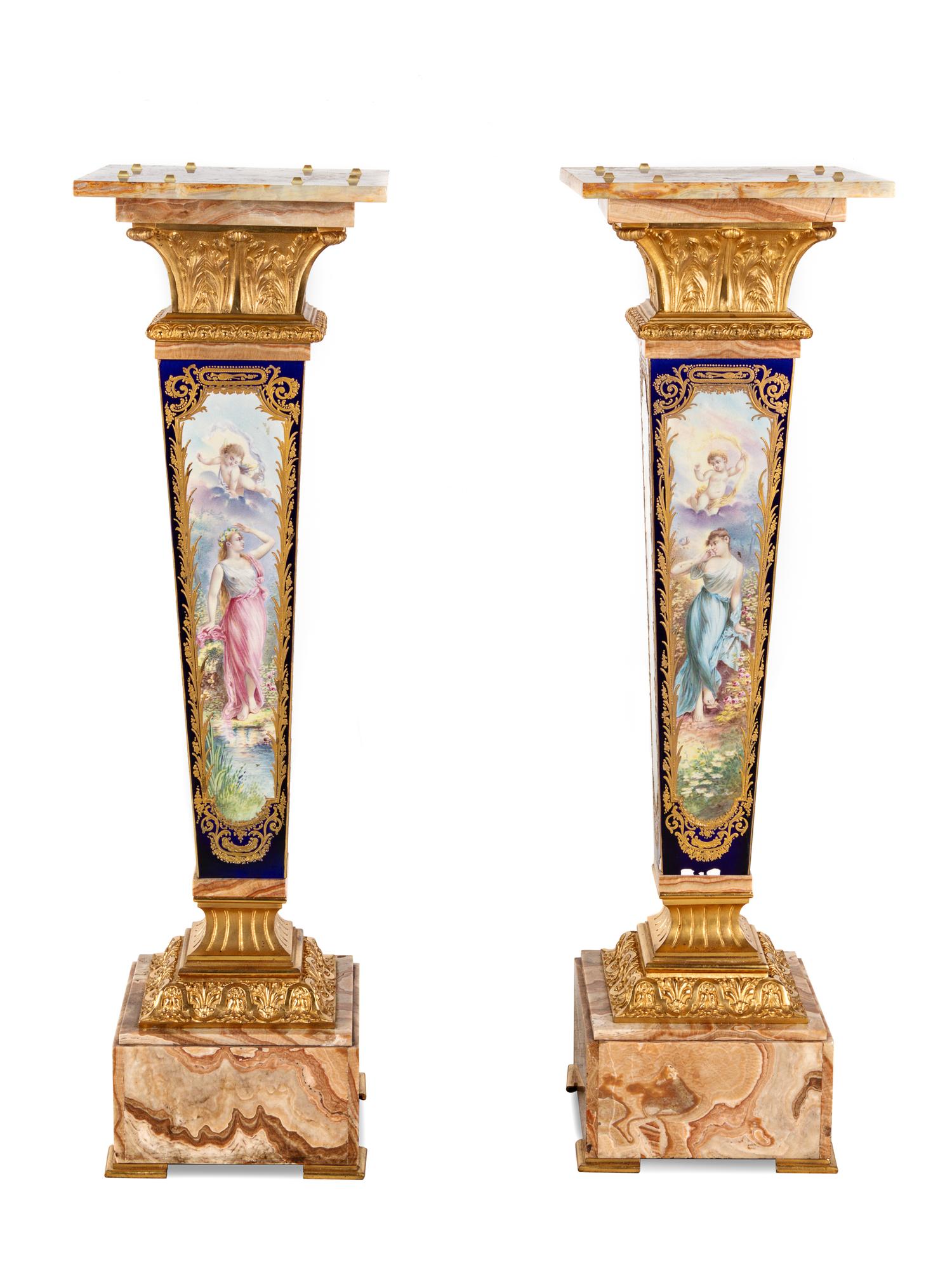 A Pair of Sèvres Style Gilt Bronze Mounted Painted and Parcel Gilt Porcelain and Onyx Pedestals