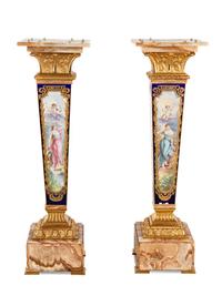 A Pair of Sèvres Style Gilt Bronze Mounted Painted and Parcel Gilt Porcelain and Onyx Pedestals