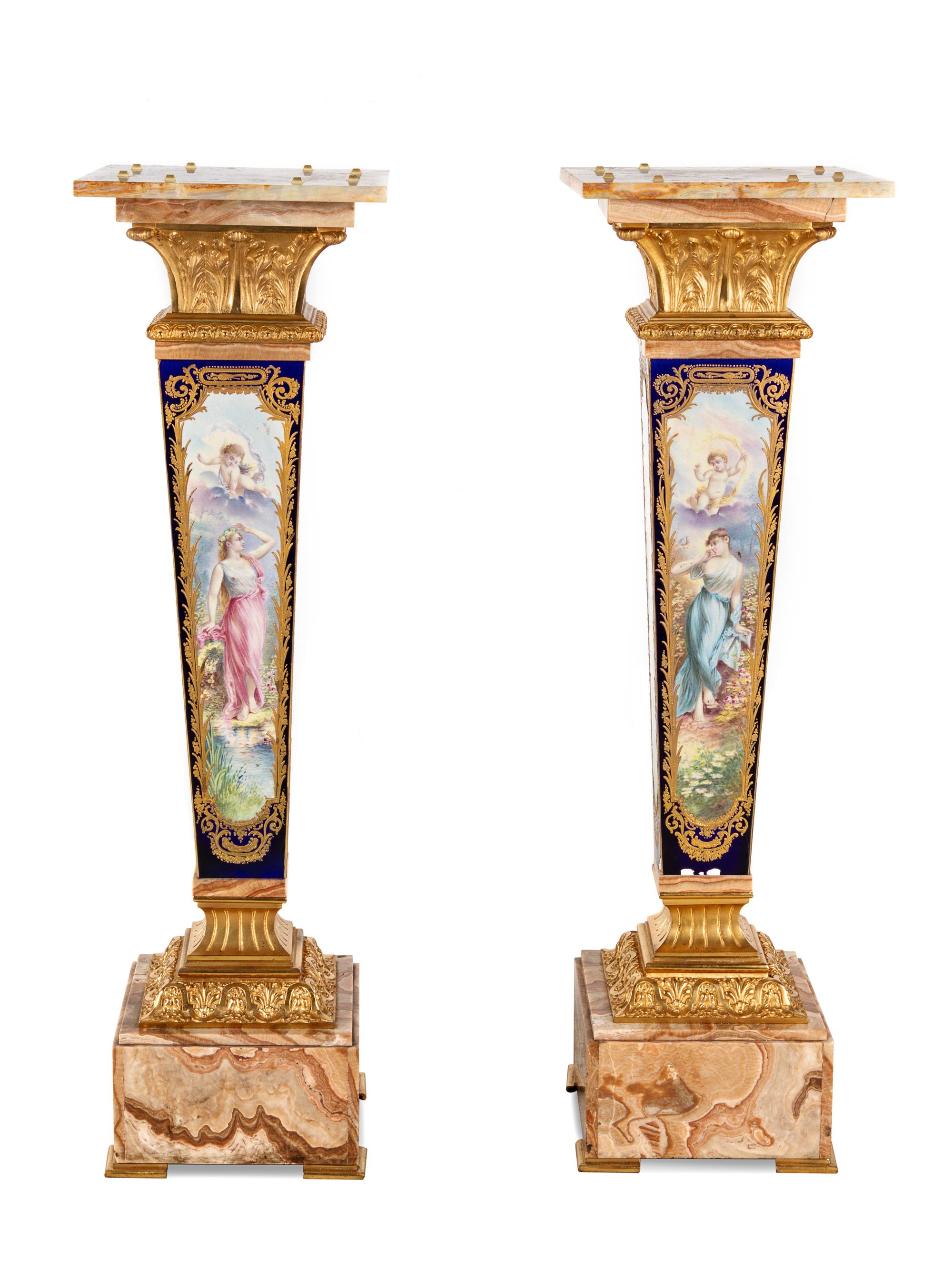 A Pair of Sèvres Style Gilt Bronze Mounted Painted and Parcel Gilt Porcelain and Onyx Pedestals
