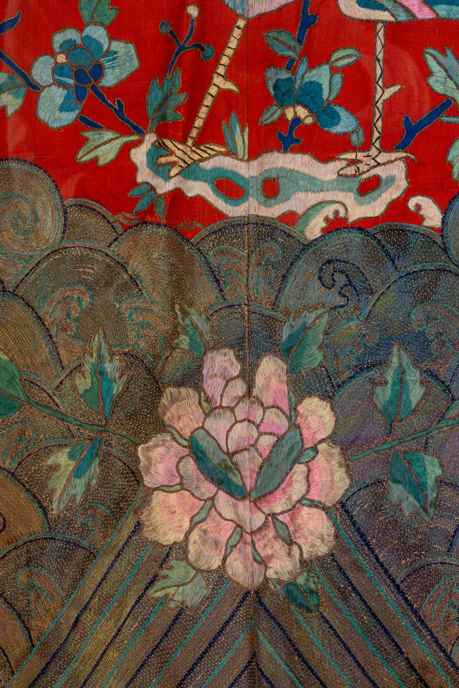 A Chinese Red Ground and Embroidered Silk 'Peacock' Robe