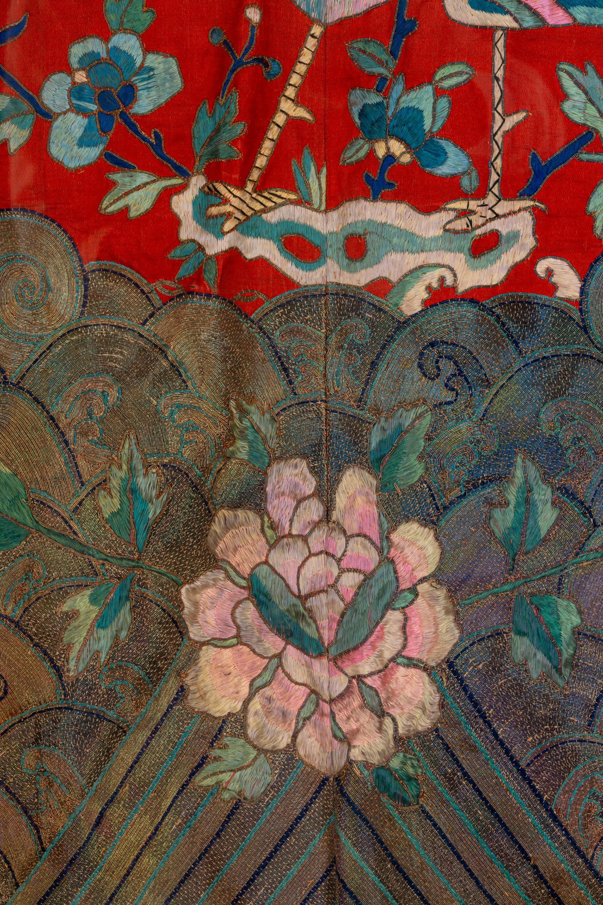 A Chinese Red Ground and Embroidered Silk 'Peacock' Robe