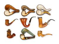 A Group of Nine Carved Meerschaum and Wooden Pipes