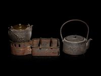 Seven Japanese Cast Iron Teapots, Tetsubin, and Burner
