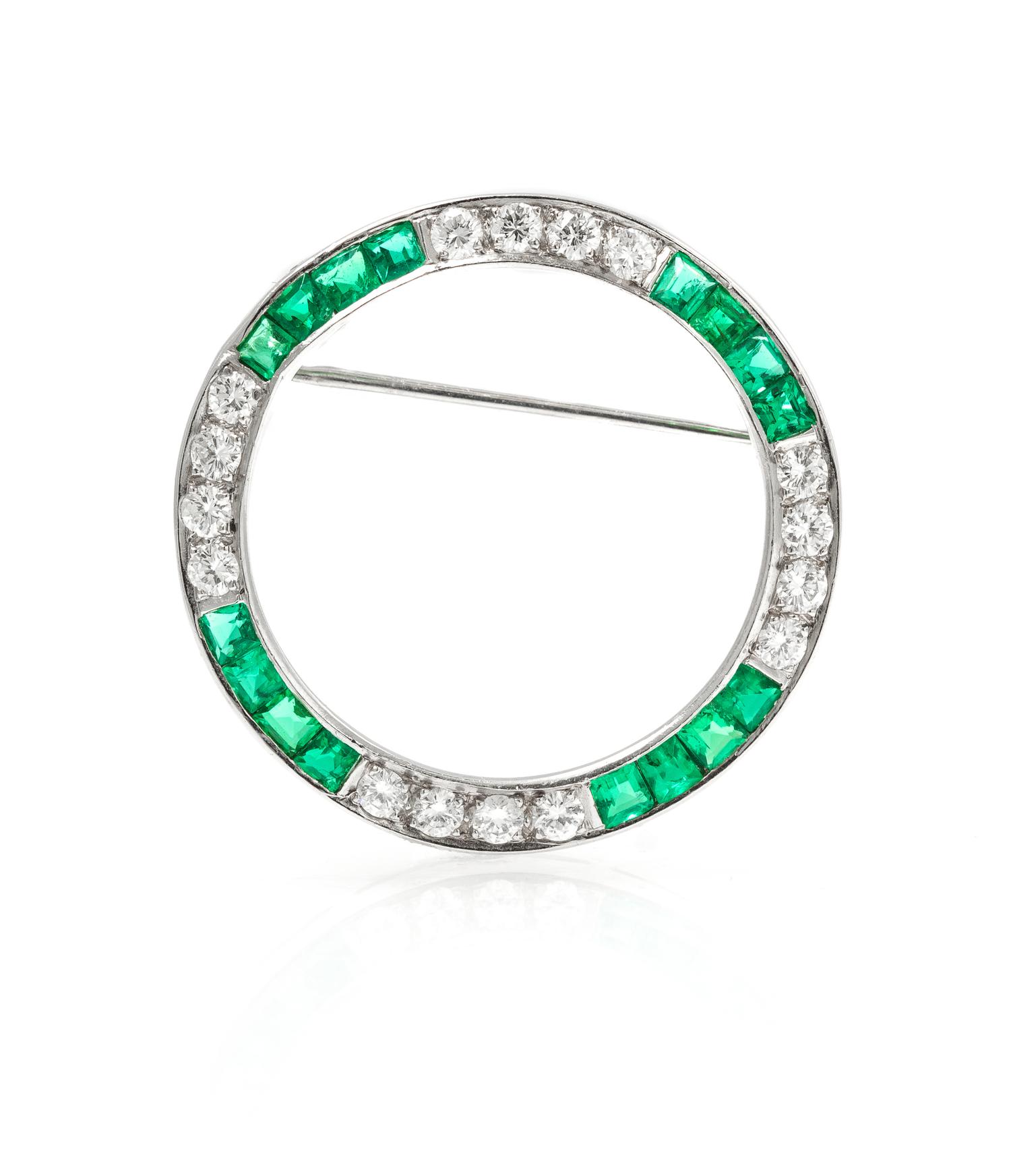 A Platinum, Diamond, and Emerald Circle Brooch, 4.40 dwts.