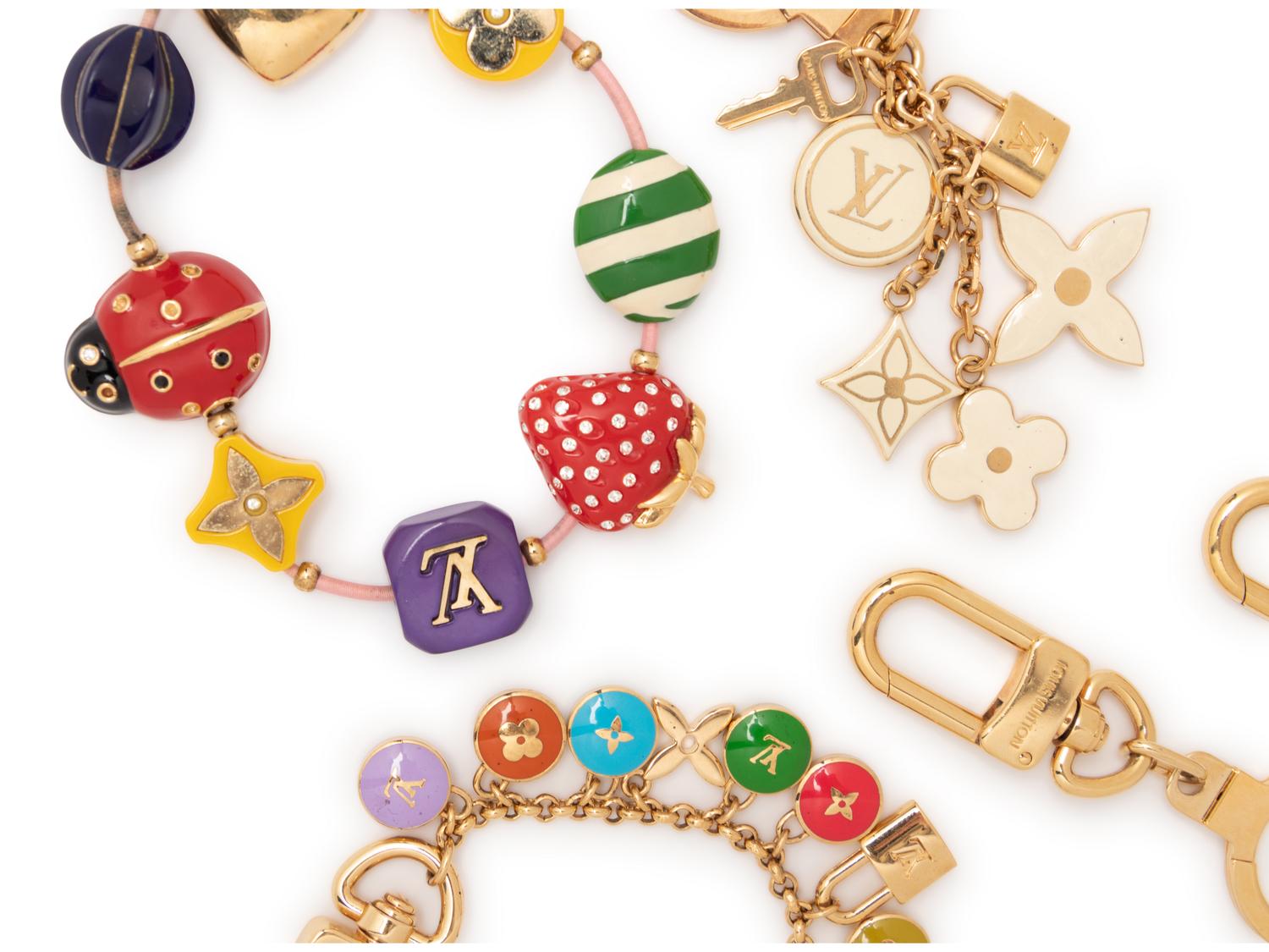 Five Louis Vuitton pieces, 2000-10s: One Bracelet & Four Purse/Key Chains