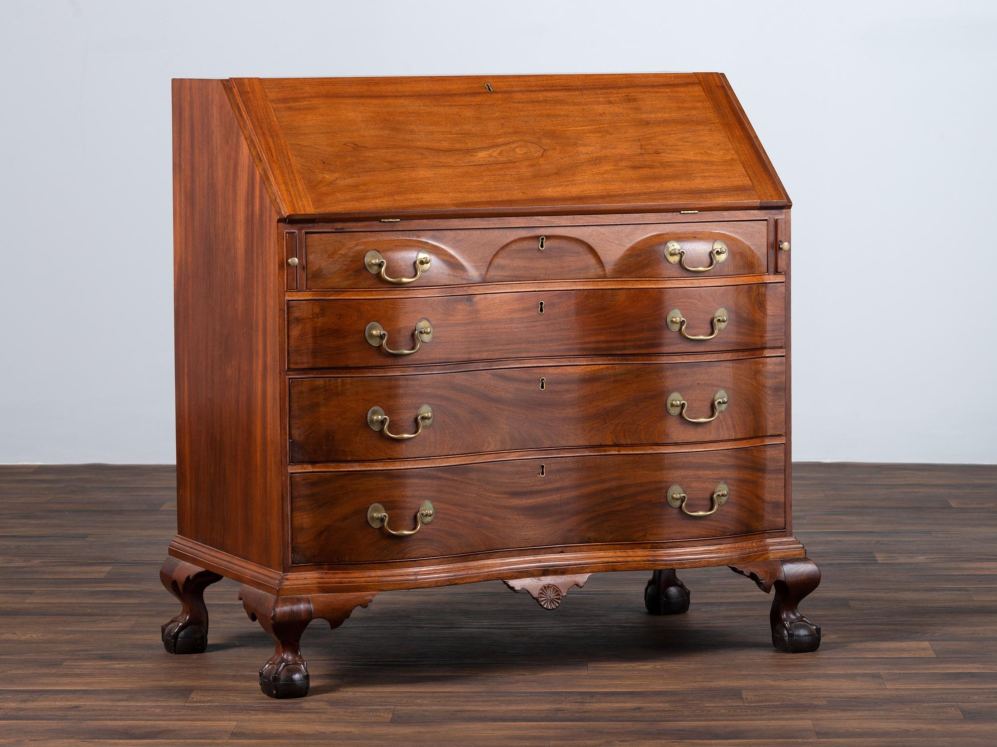 A Chippendale Carved Mahogany Reverse Serpentine Block-Front Desk