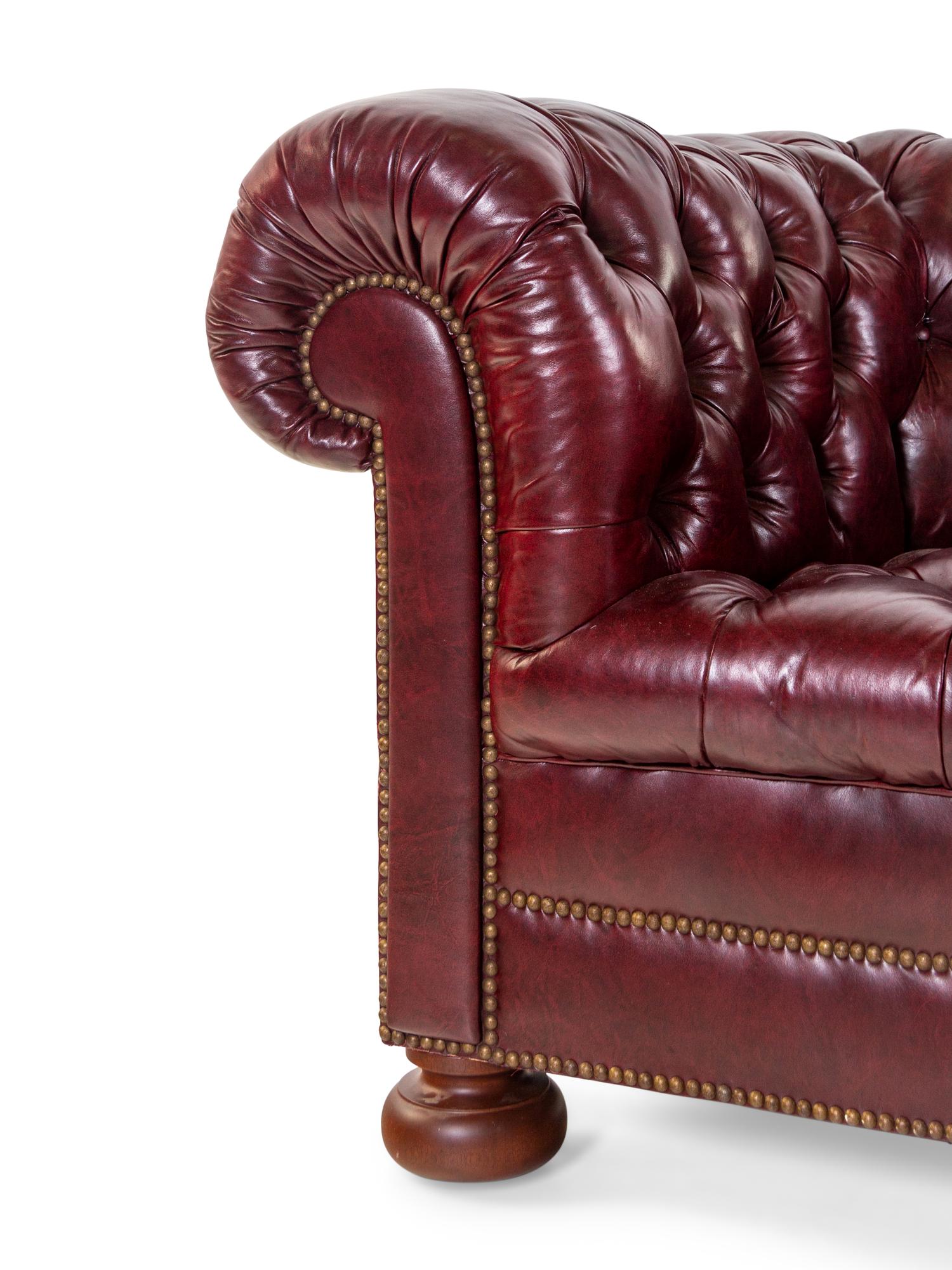 A Tufted Faux Leather Upholstered Chesterfield Sofa