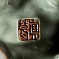 A Japanese Celadon-Glazed Monju on Lion, Impressed Seal Makuzu