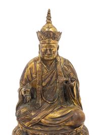 A Tibetan Gilt Bronze Figure of a Seated Guru