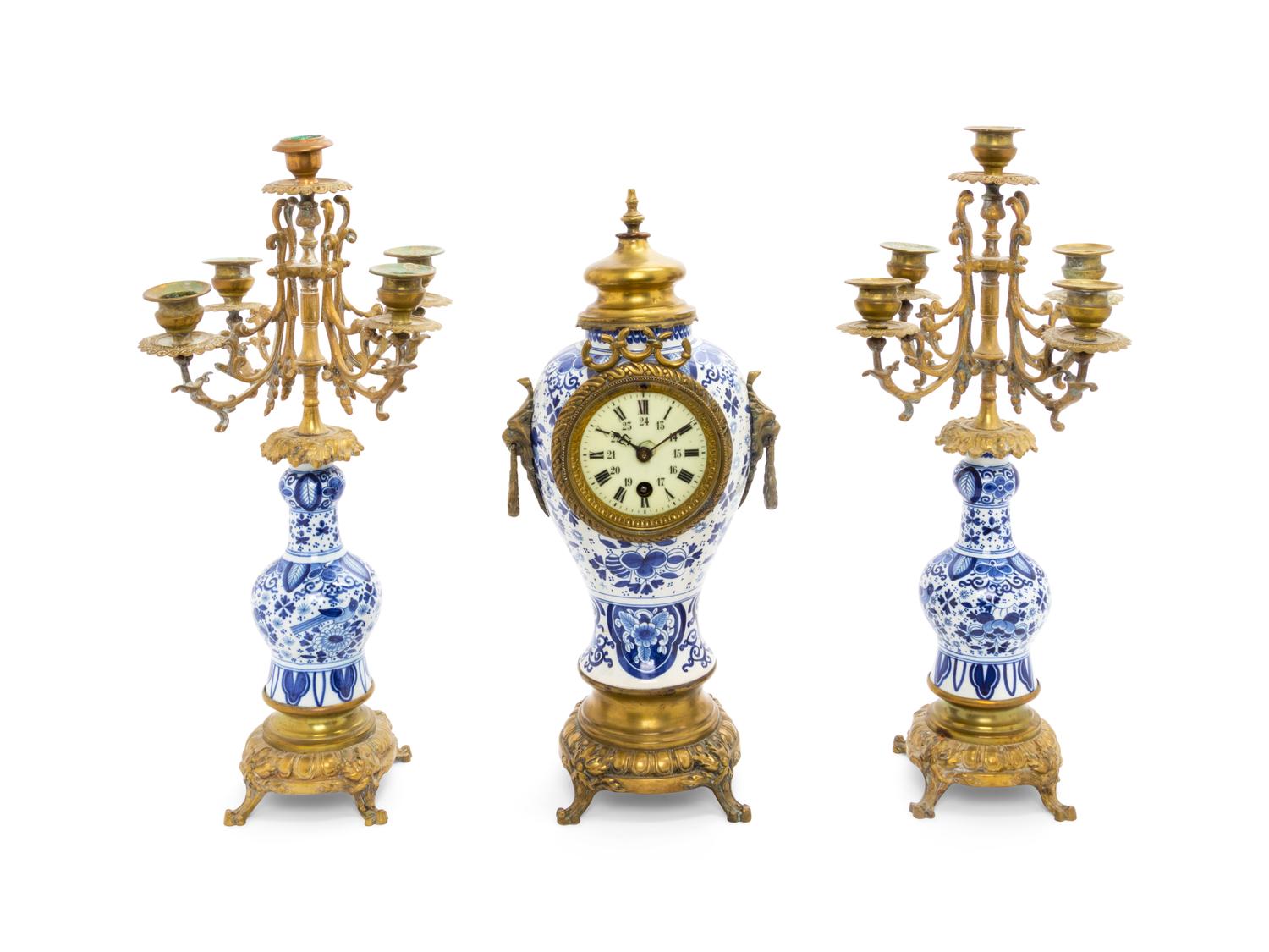 A Delft Pottery Three-Piece Clock Garniture