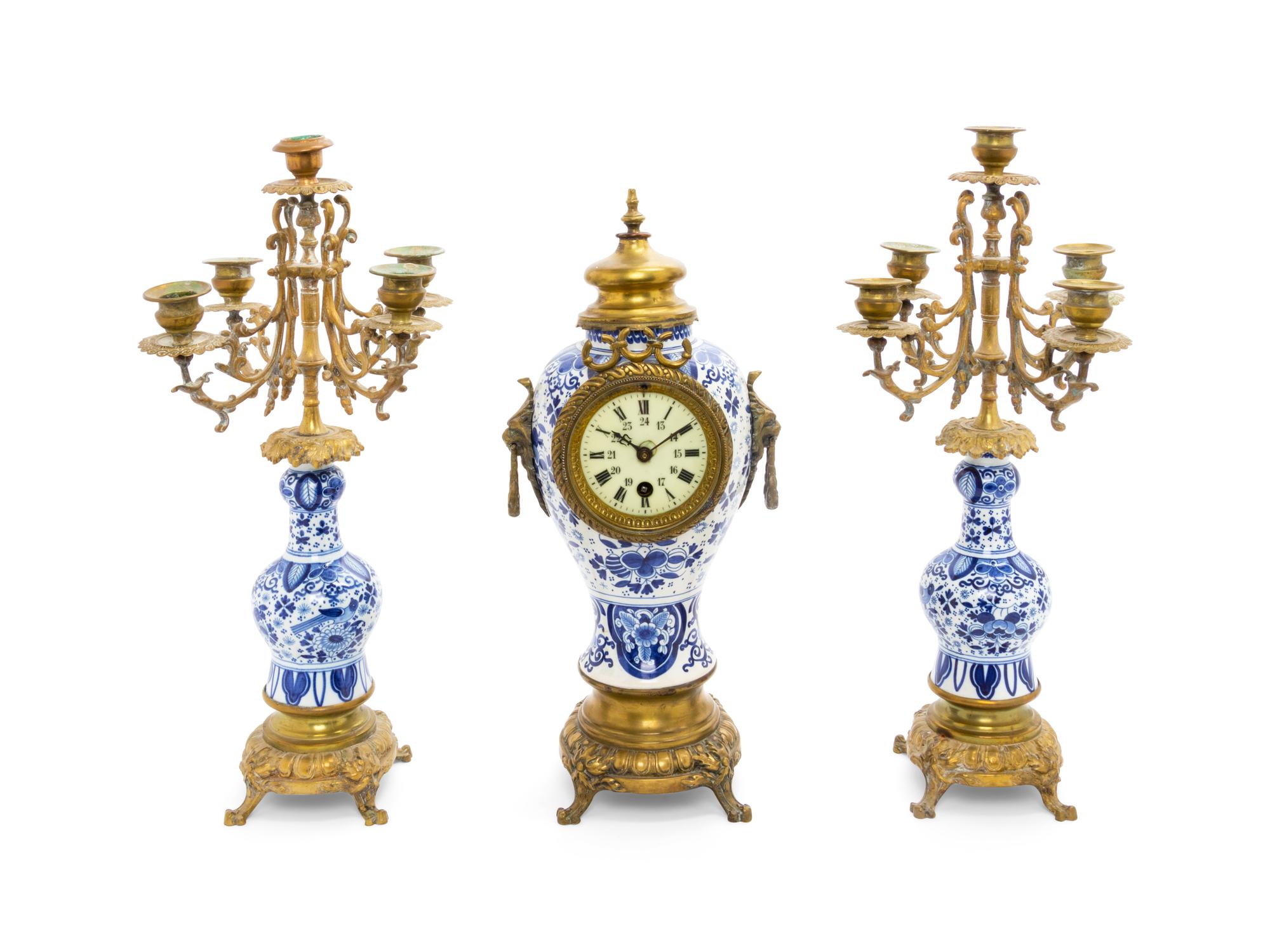 A Delft Pottery Three-Piece Clock Garniture