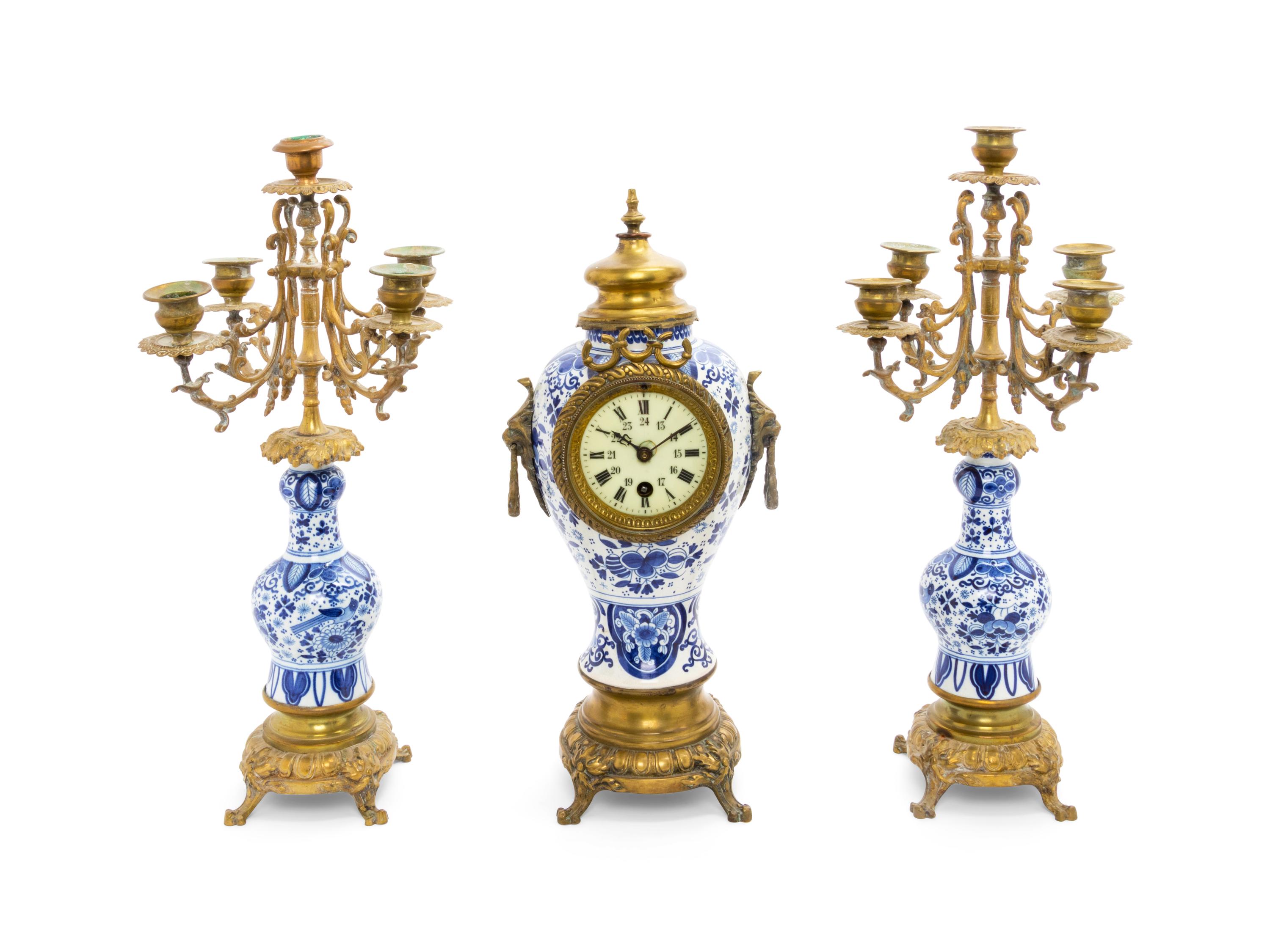 A Delft Pottery Three-Piece Clock Garniture