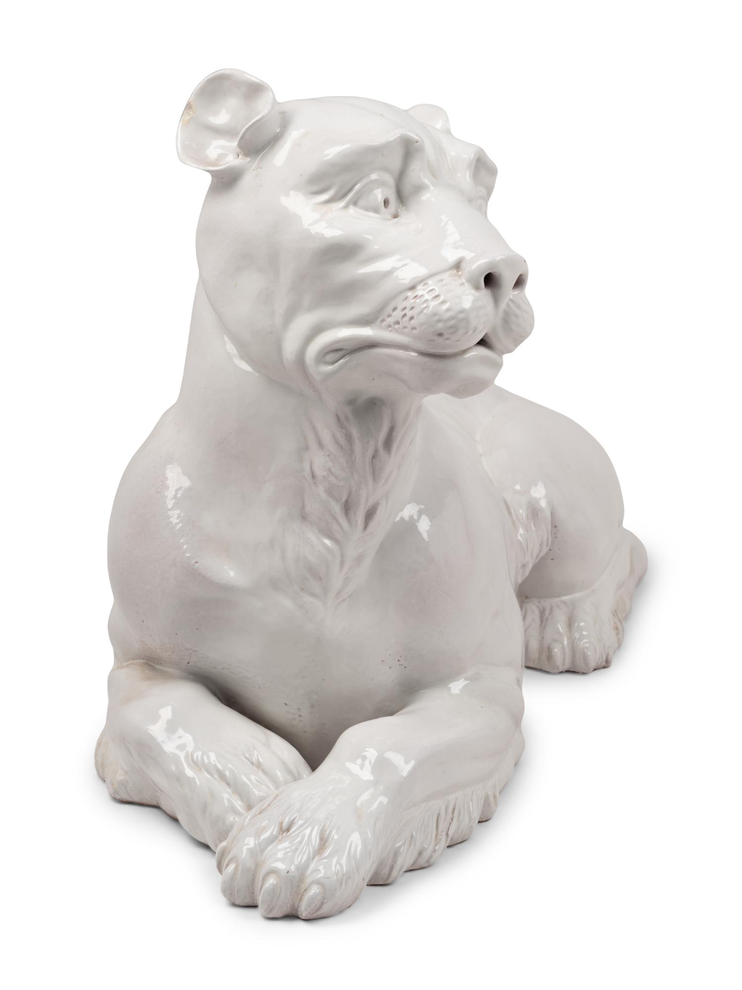 An Italian Painted Terra Cotta Figure of a Recumbent Dog