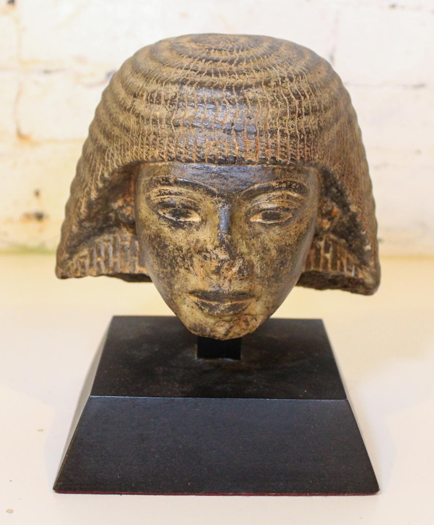 An Egyptian Style Cast Stone Bust. Height 6 1/2 inches.