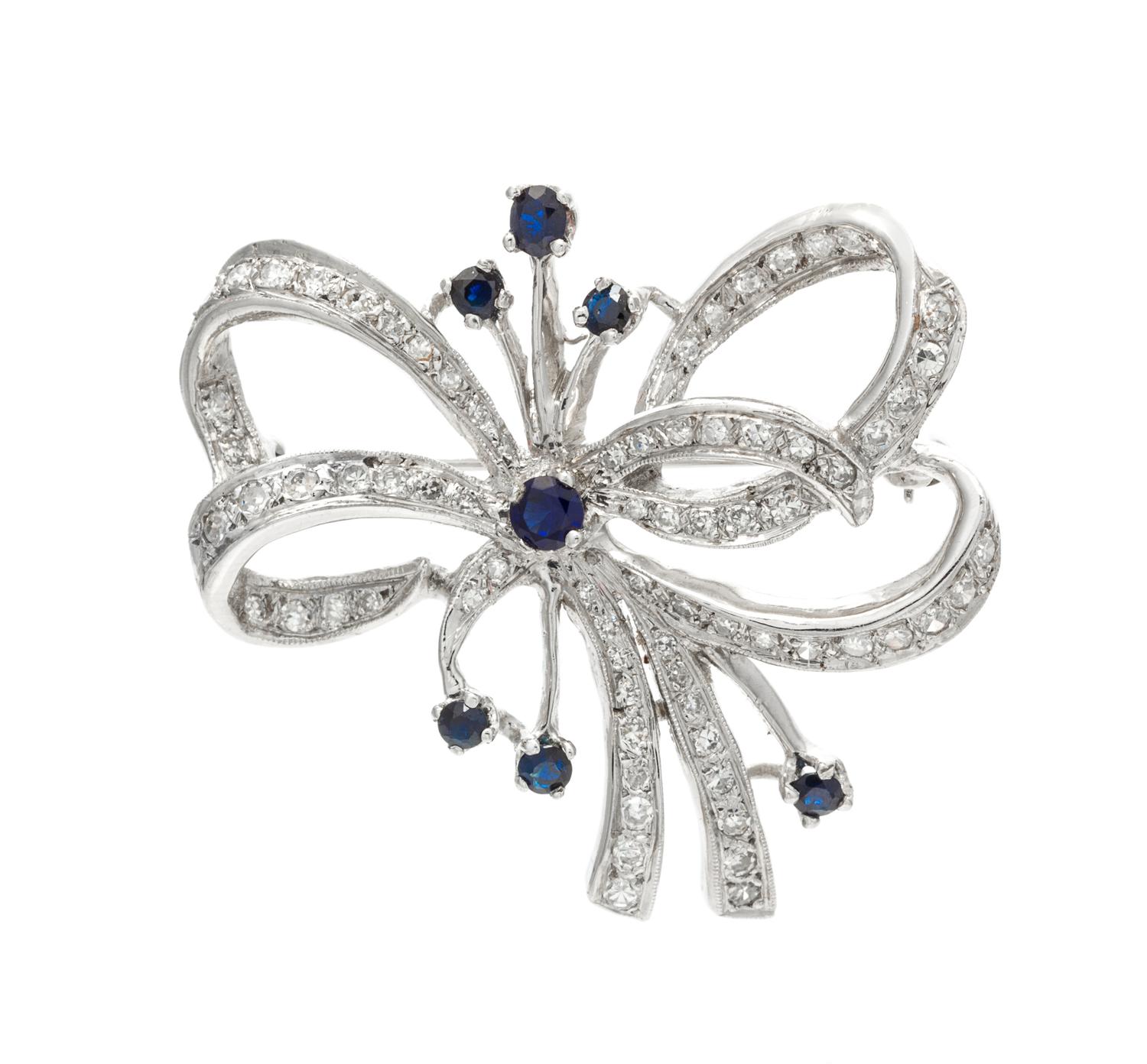A White Gold, Sapphire and Diamond Bow Pendant/Brooch, 6.80 dwts.