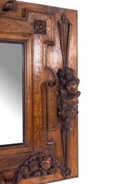 A Continental Carved Oak Mirror