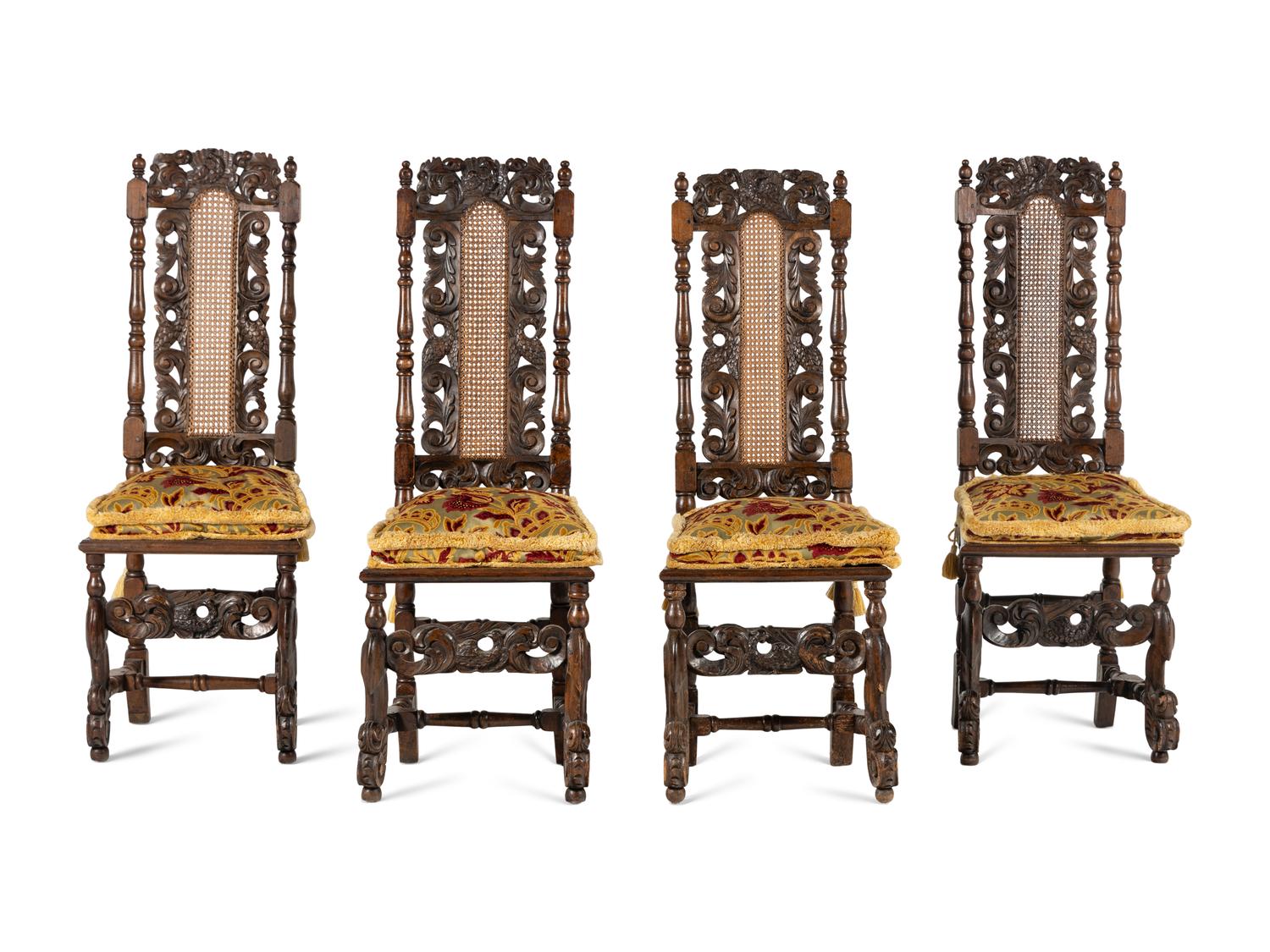 A Set of Four William and Mary Style Carved Oak Dining Chairs