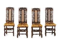A Set of Four William and Mary Style Carved Oak Dining Chairs