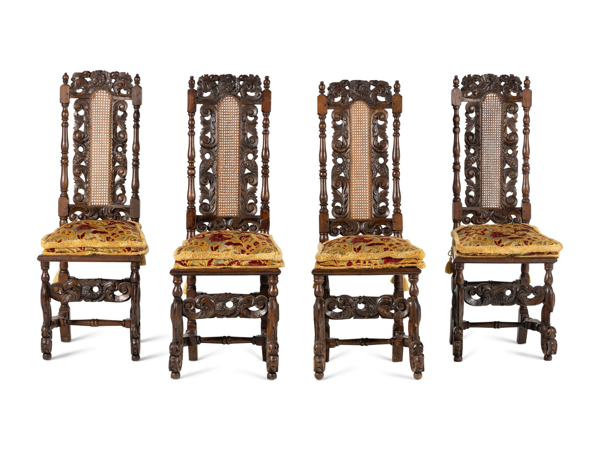A Set of Four William and Mary Style Carved Oak Dining Chairs