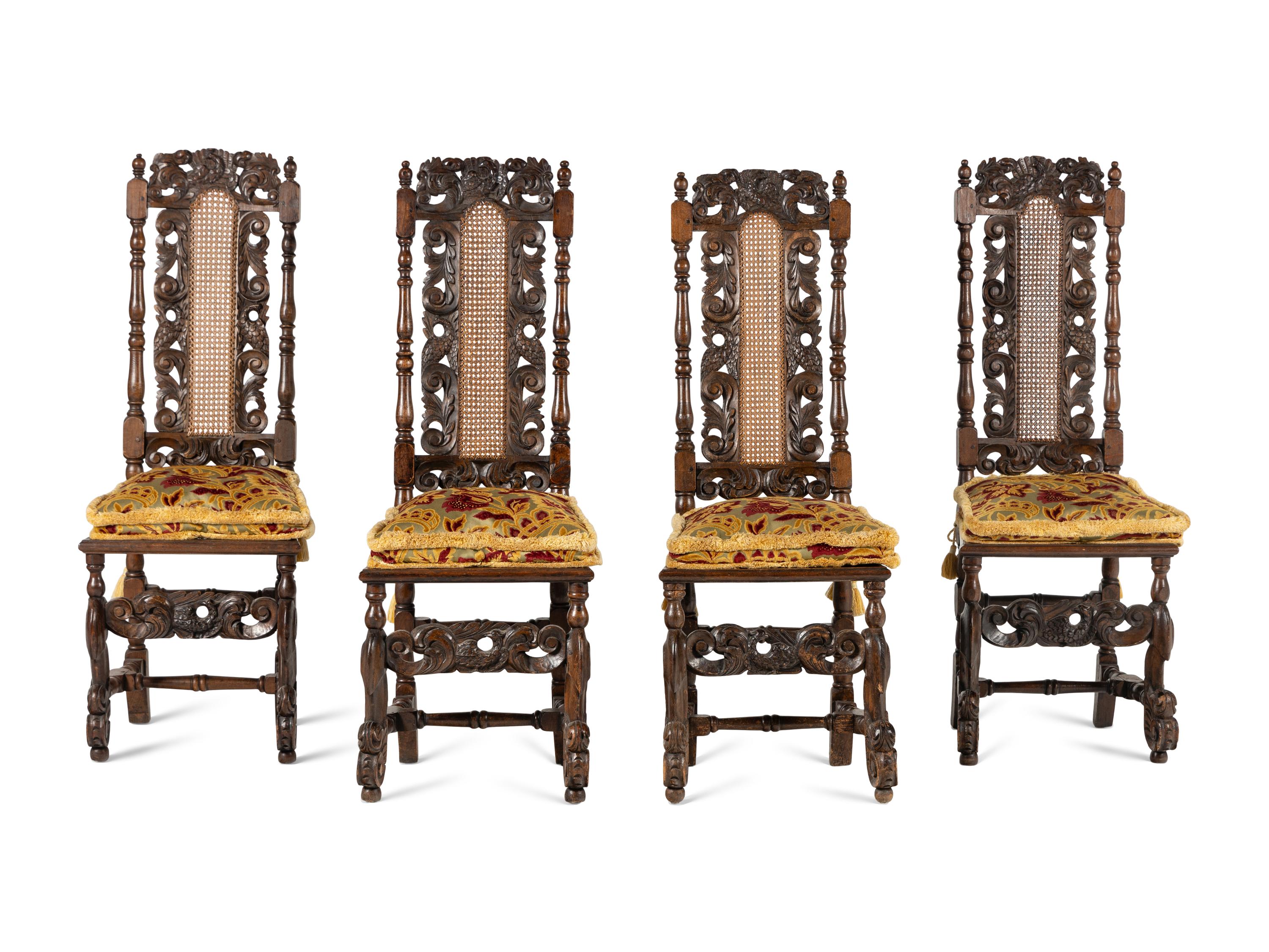 A Set of Four William and Mary Style Carved Oak Dining Chairs
