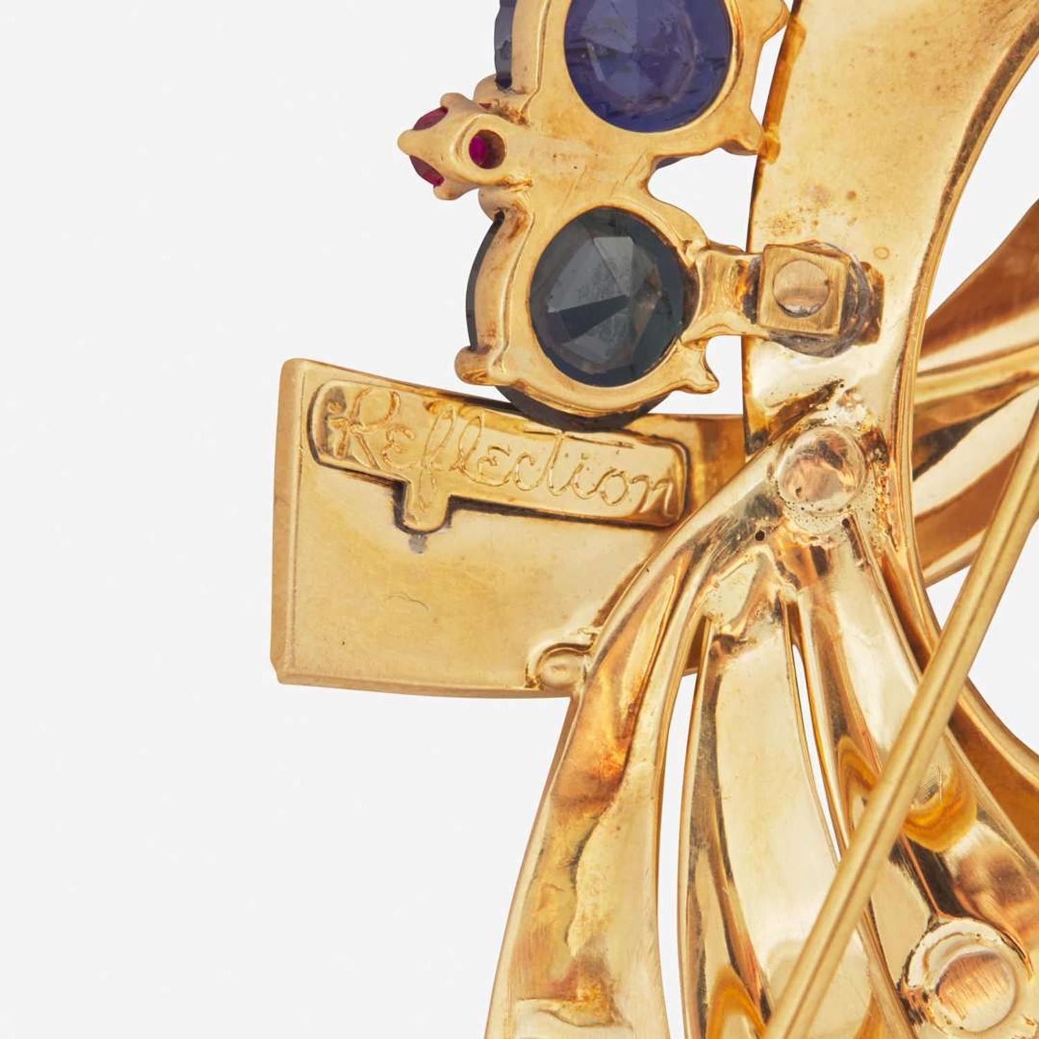 A 14K Yellow Gold, Sapphire, and Rubies Brooch Reflections By Trabert & Hoeffer Mauboussin