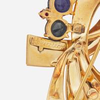 A 14K Yellow Gold, Sapphire, and Rubies Brooch Reflections By Trabert & Hoeffer Mauboussin