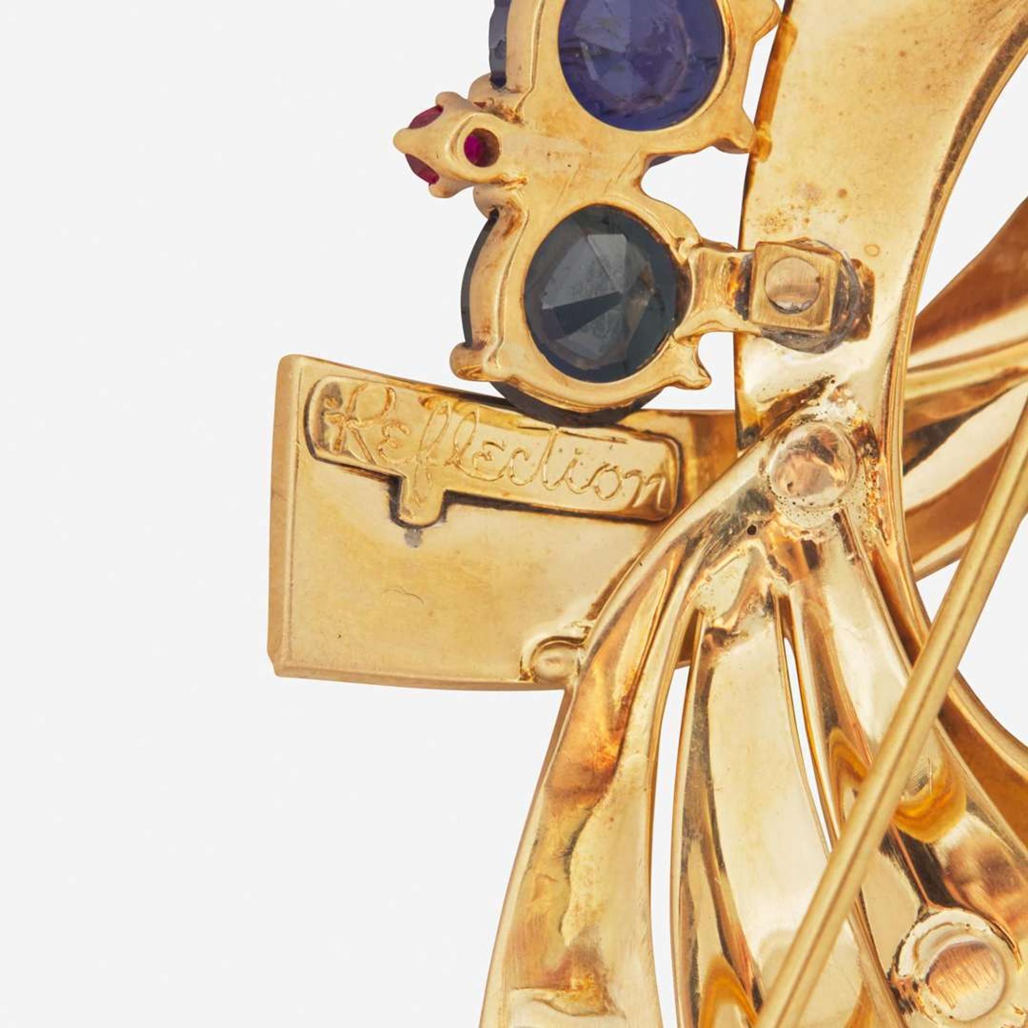 A 14K Yellow Gold, Sapphire, and Rubies Brooch Reflections By Trabert & Hoeffer Mauboussin