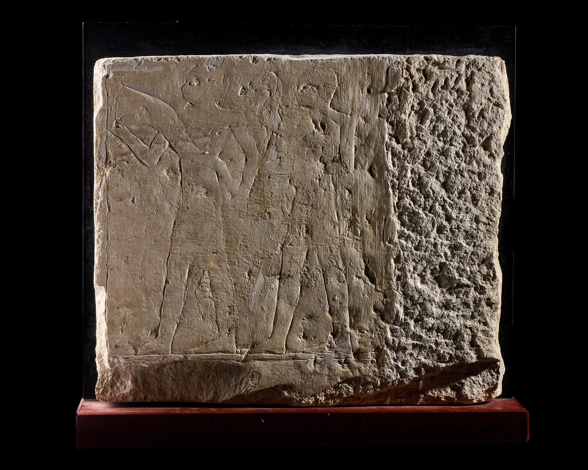 An Egyptian Limestone Relief Fragment Depicting an Offering Scene