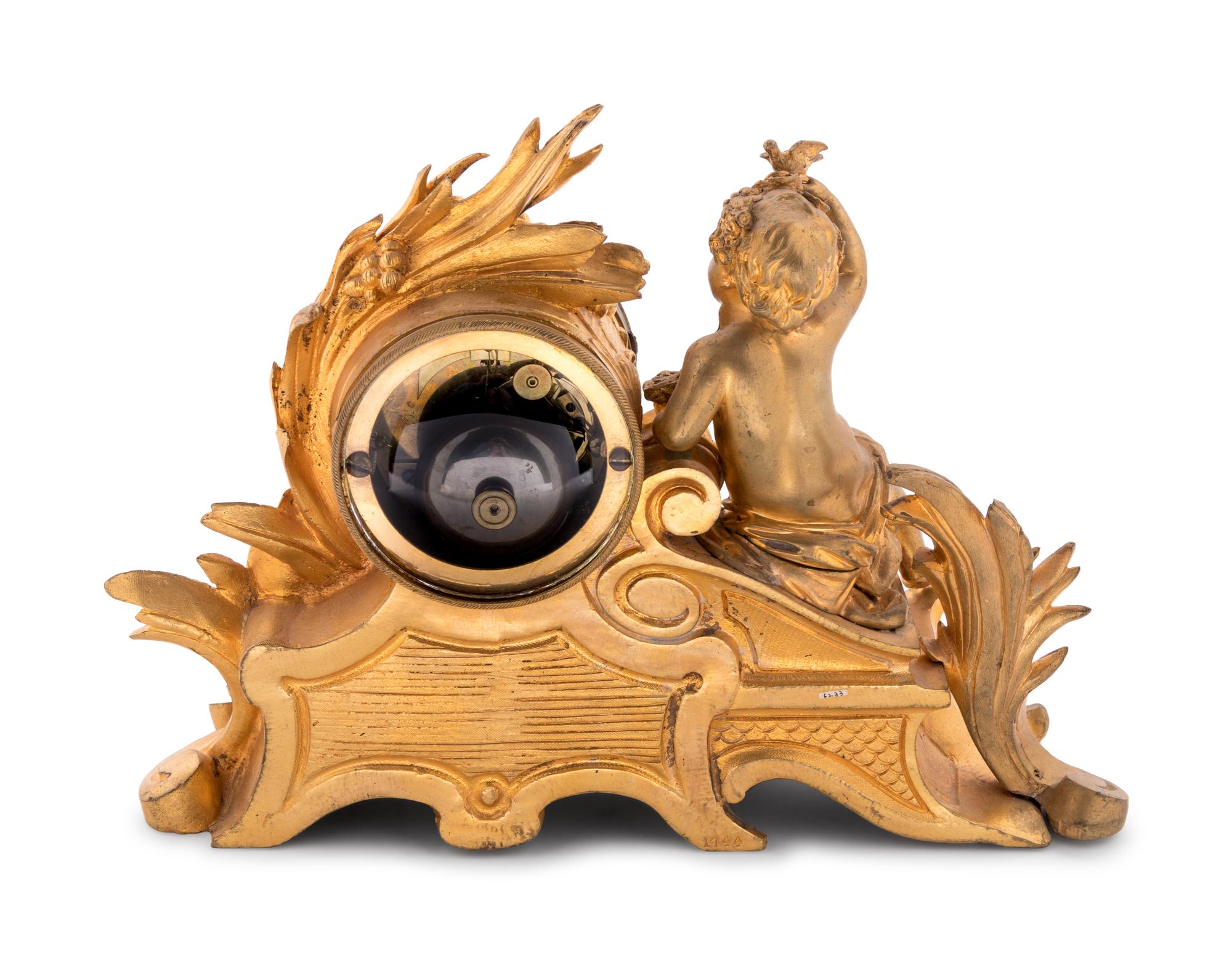 A Louis XV Style Porcelain Mounted Gilt Bronze Figural Mantel Clock