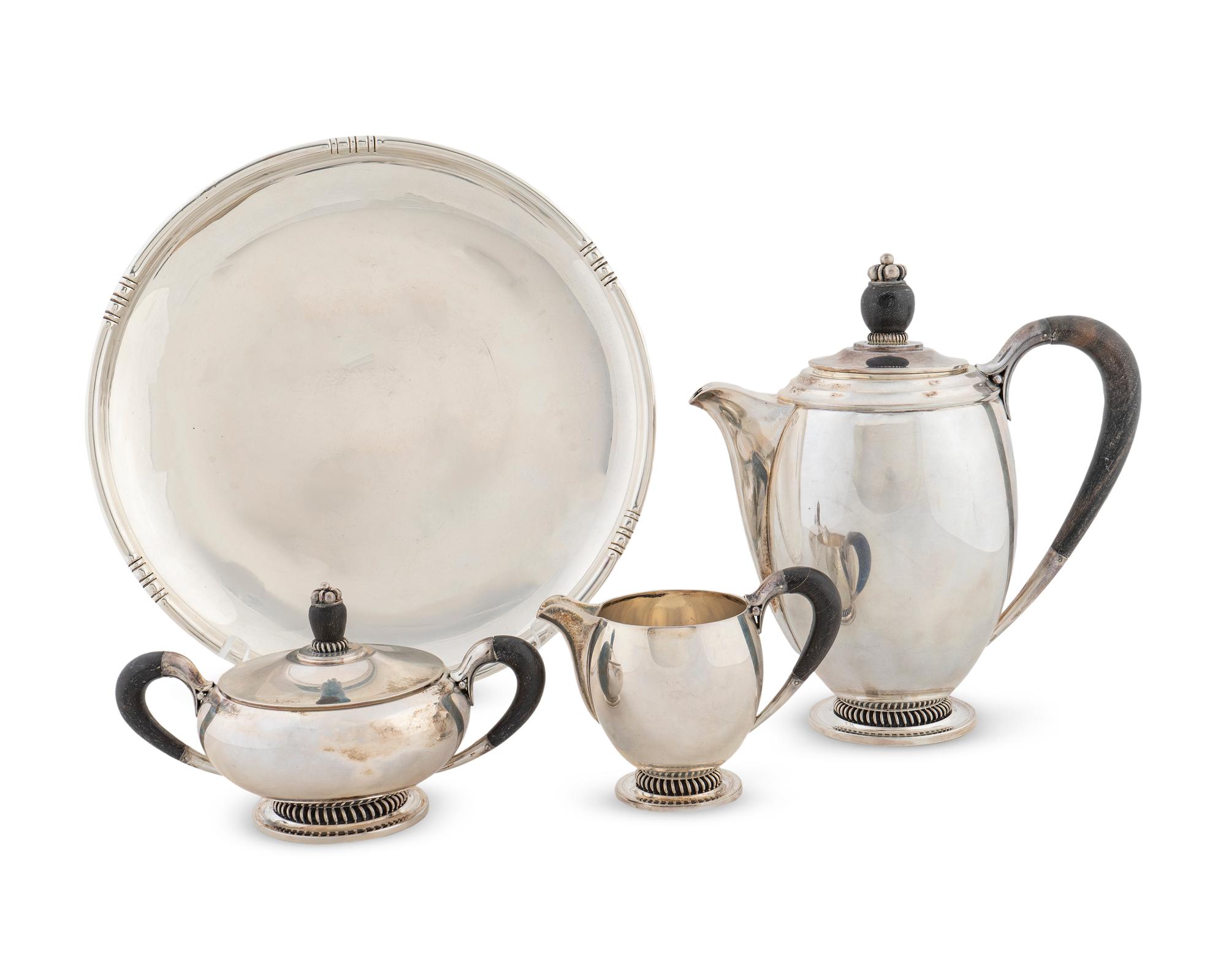 A Danish Silver Three-Piece Tea Set and a Fina Circular Silver Tray — THE TEASET CC HERMANN, DENMARK