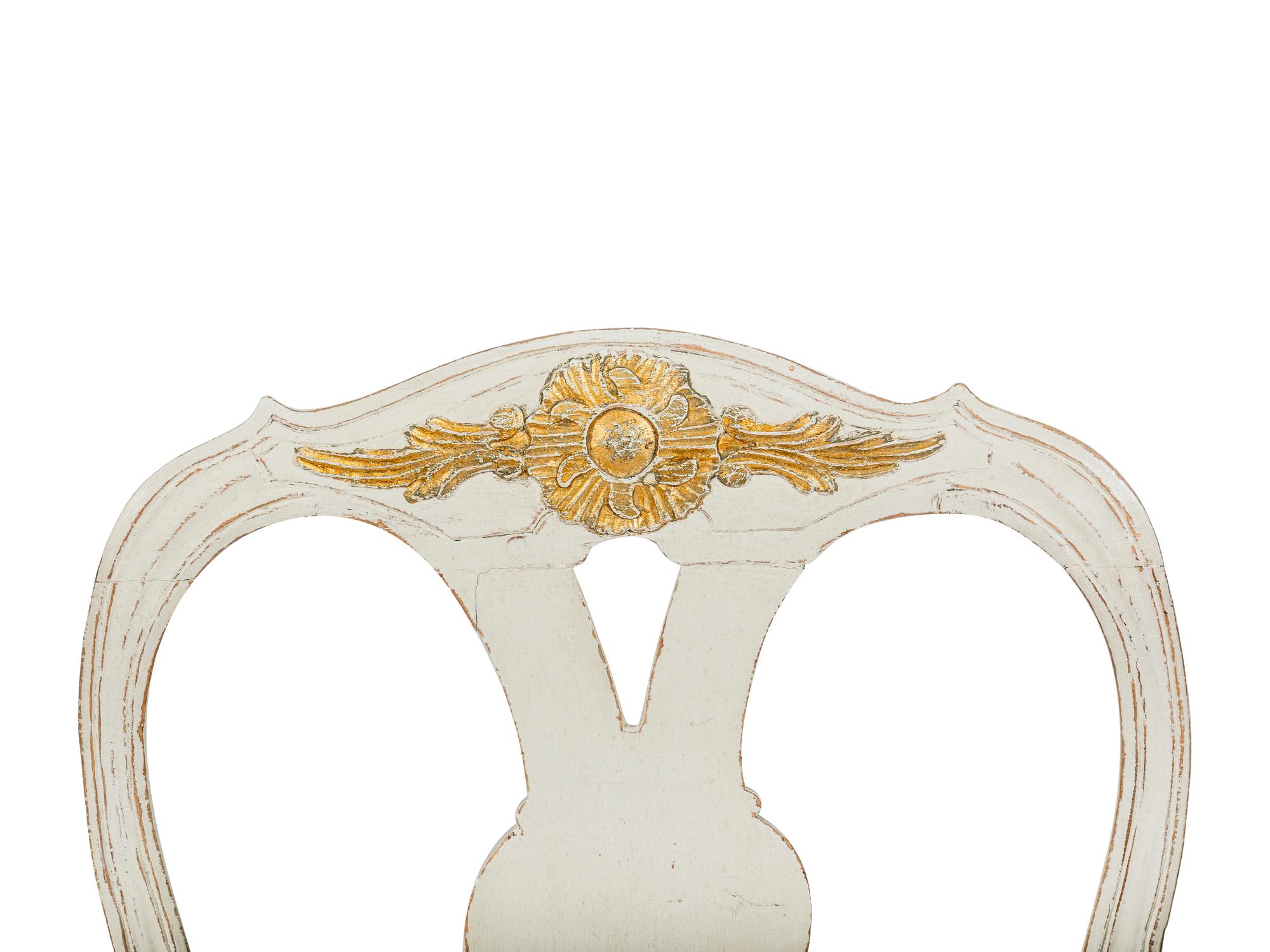 A Pair of Swedish White-Painted and Parcel-Gilt Open Armchairs