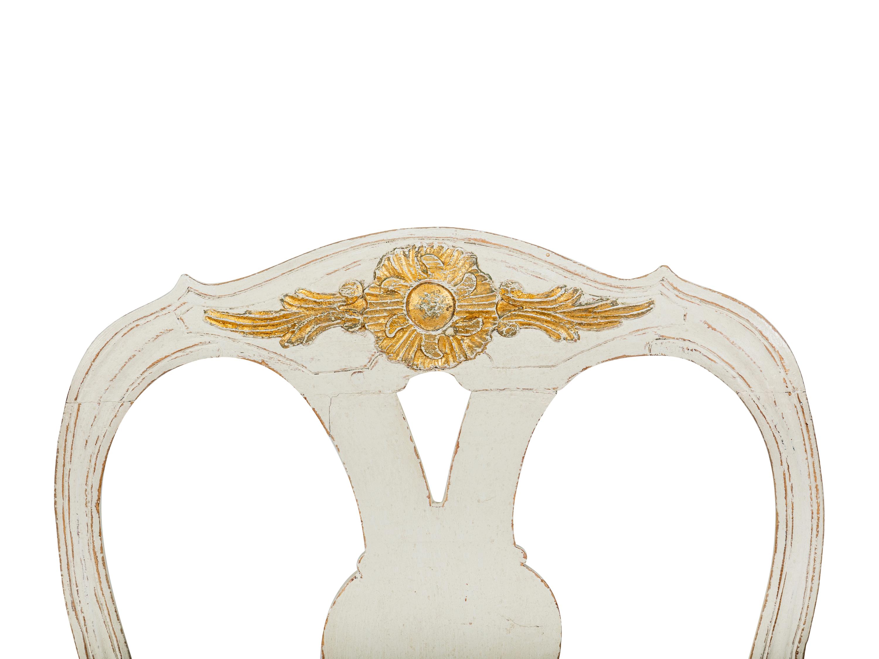 A Pair of Swedish White-Painted and Parcel-Gilt Open Armchairs