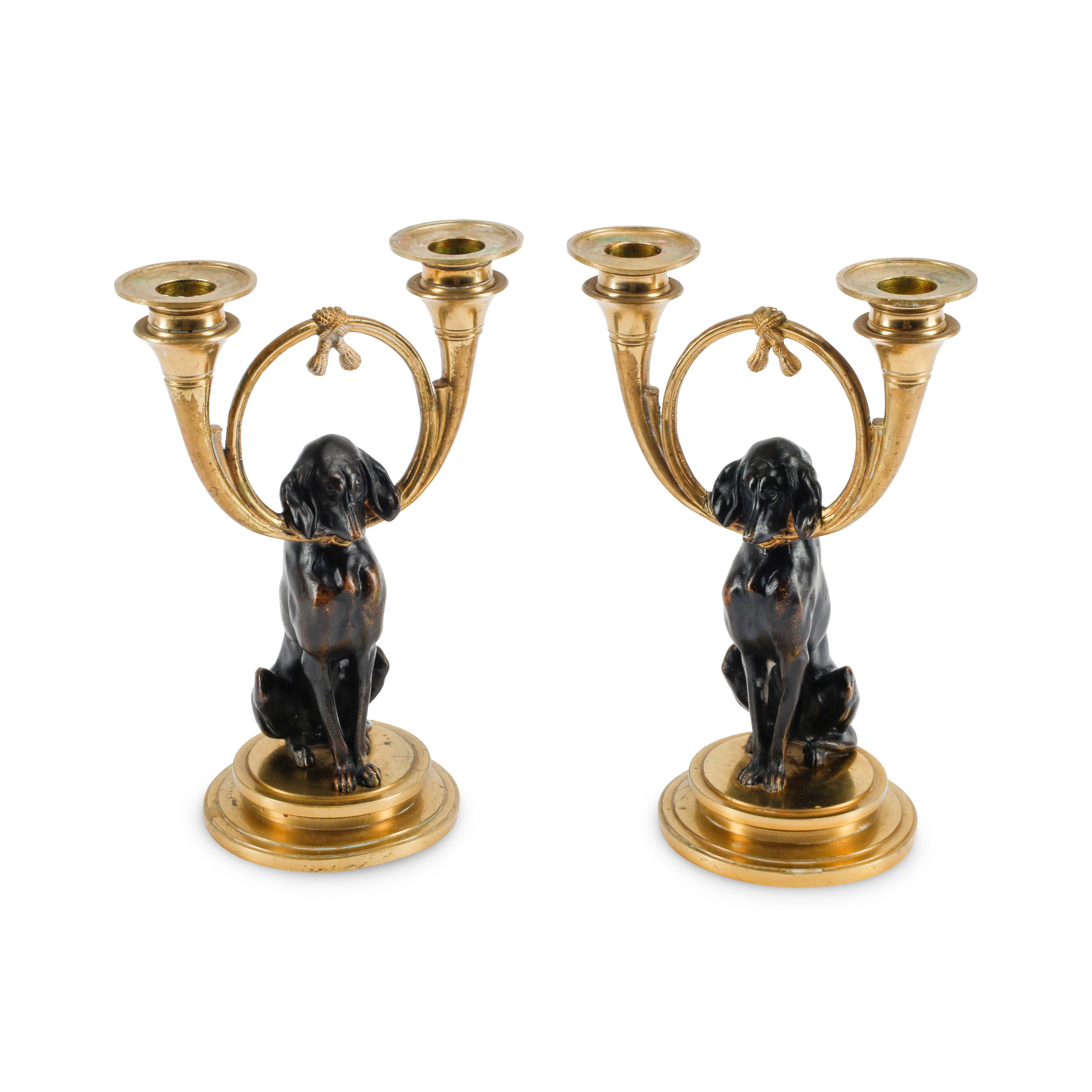 A Pair of Gilt and Patinated Bronze Dog Motif Two-Light Candelabra