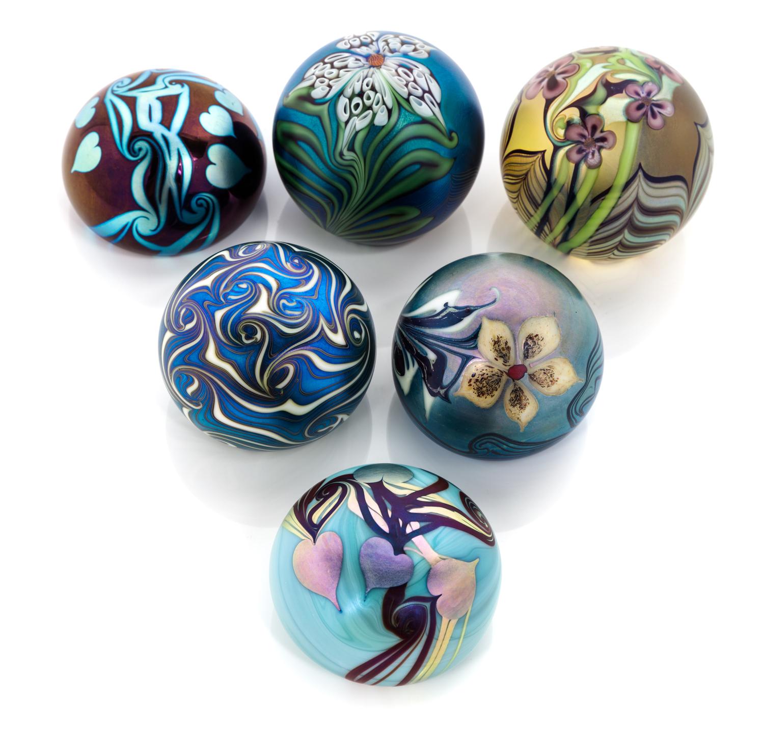 Orient & Flume, CHICO, CA, a group of six iridescent glass paperweights, 1974-1981