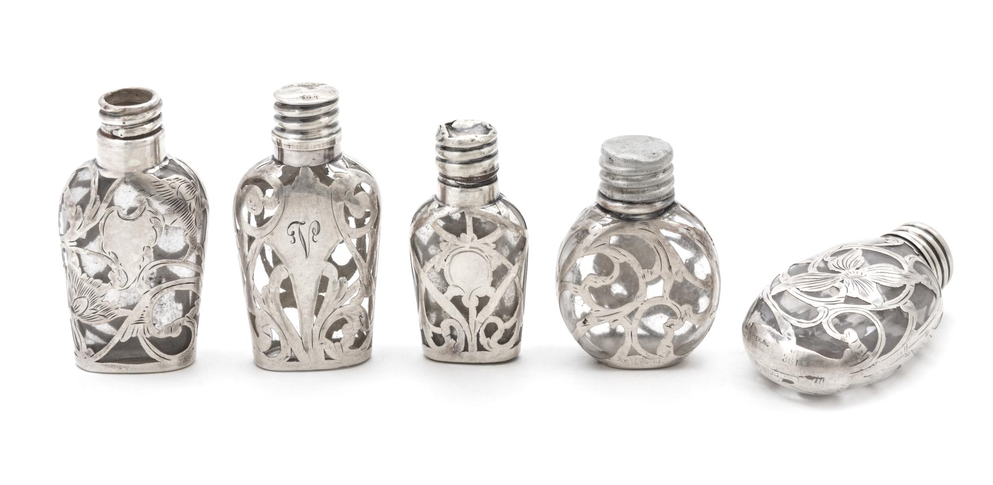 A Group of Five Silver Overlay Glass Scent Flasks Height of tallest 2 3/4 inches.