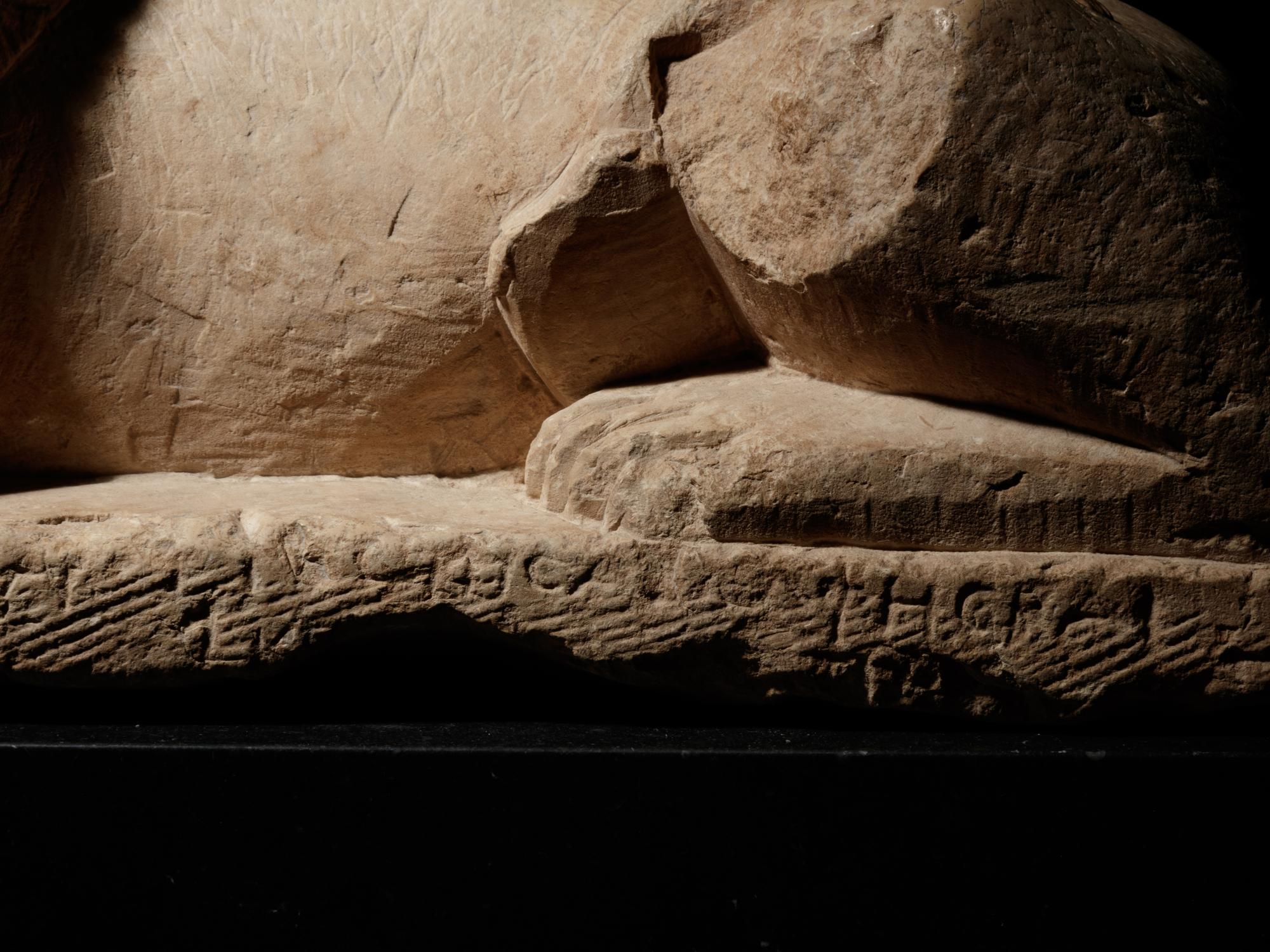 An Egyptian Limestone Recumbent Lion