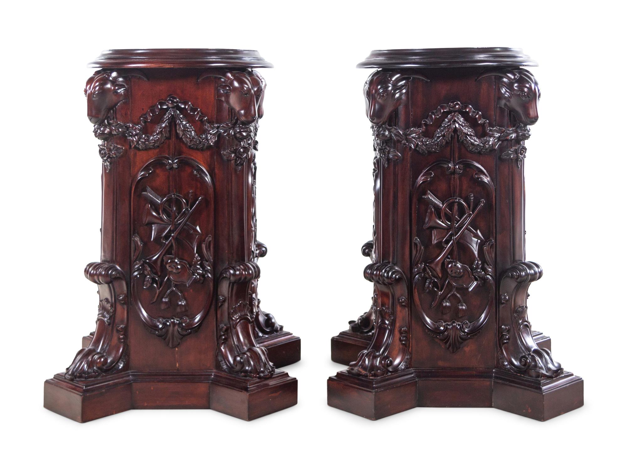 A Pair of George III Style Carved Mahogany Pedestals