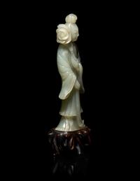 A Chinese Carved Pale Celadon Jade Standing Female Figure