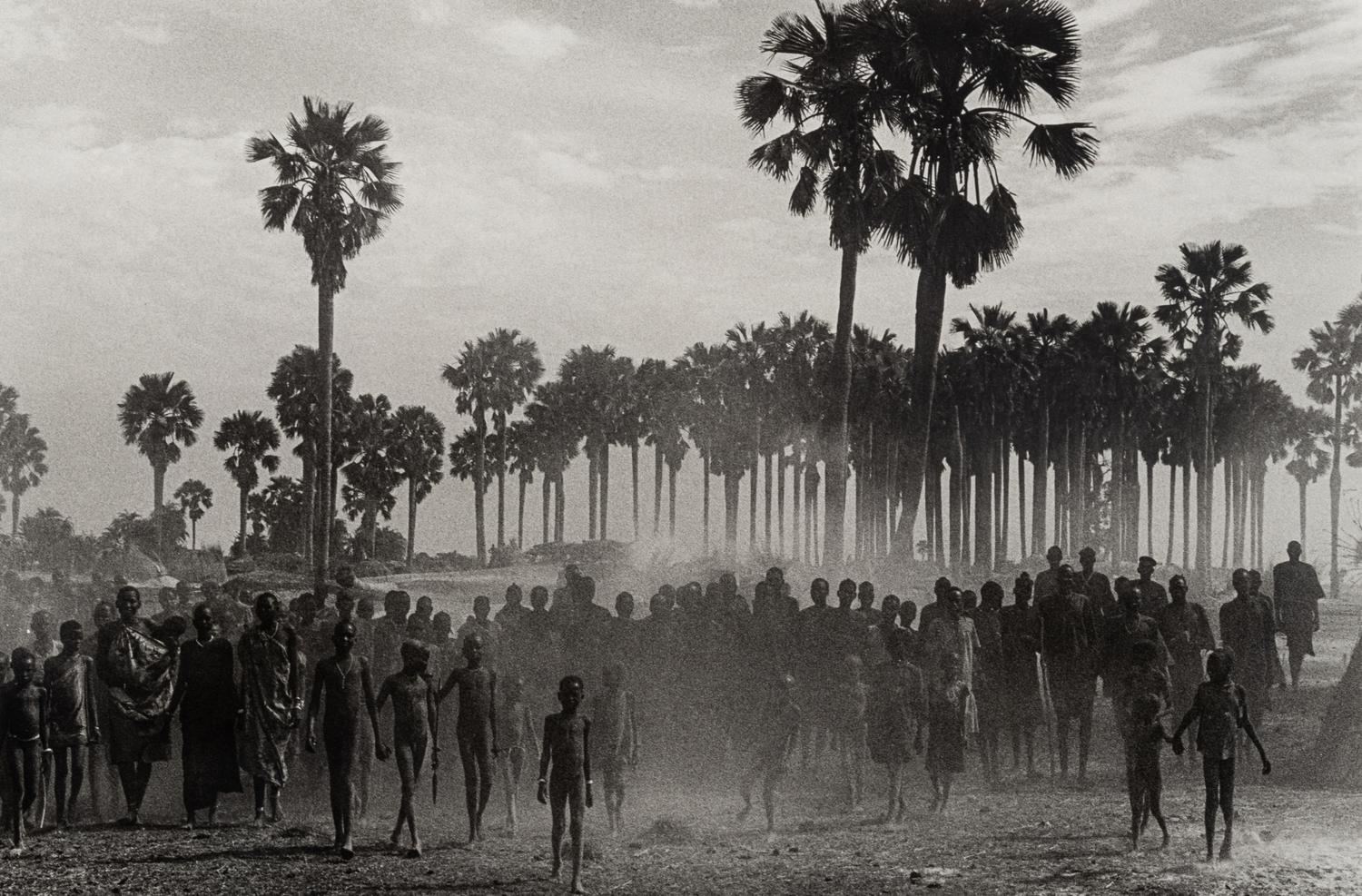Sebastião Salgado (born 1944) The population of the cattle camp of Kenya walk toward the polio vaccinators as soon as they arrive, Maper Payem area, Rumbek District, Southern Sudan, 2001