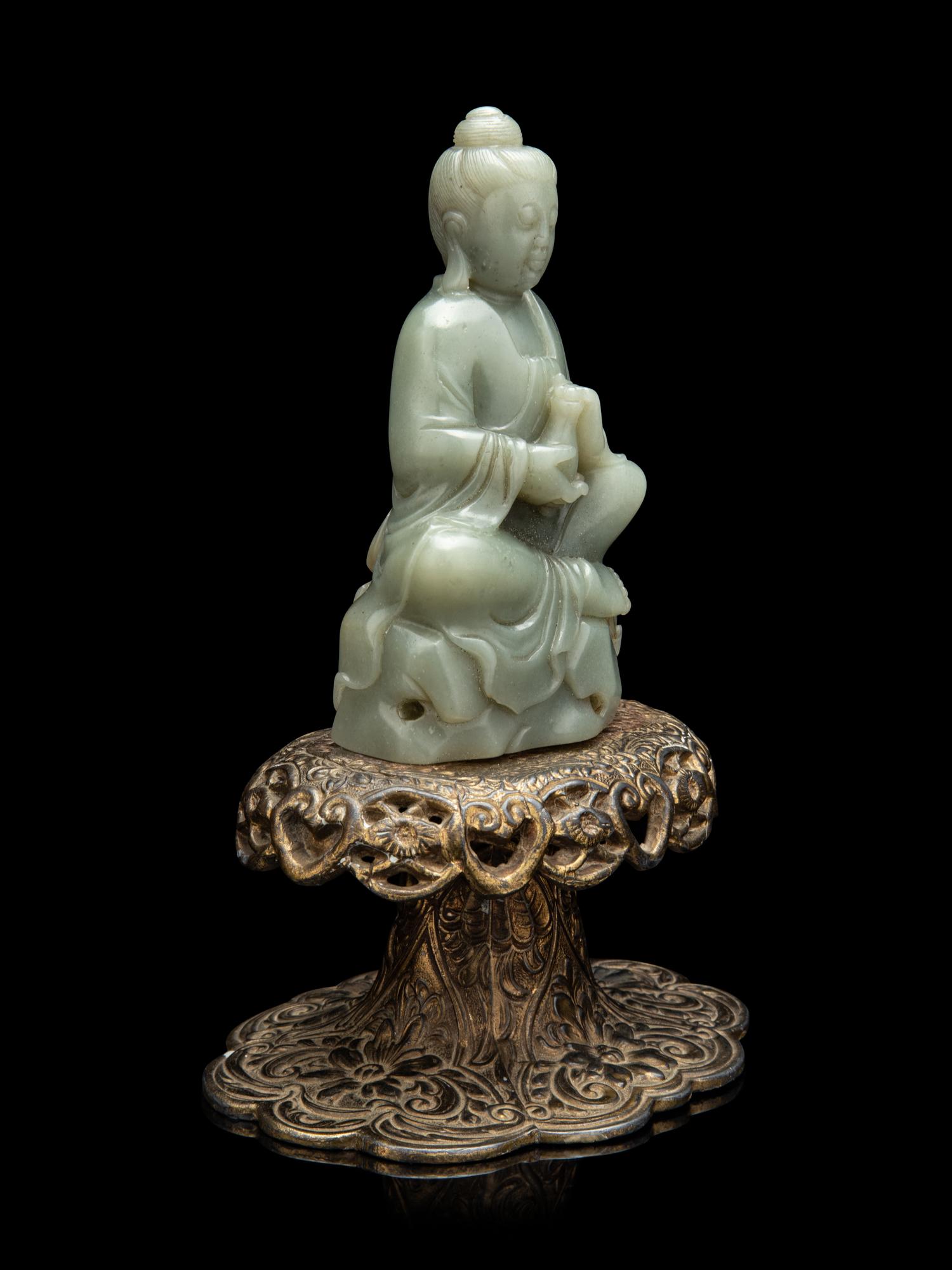 A Chinese Celadon Jade Figure of Seated Guanyin