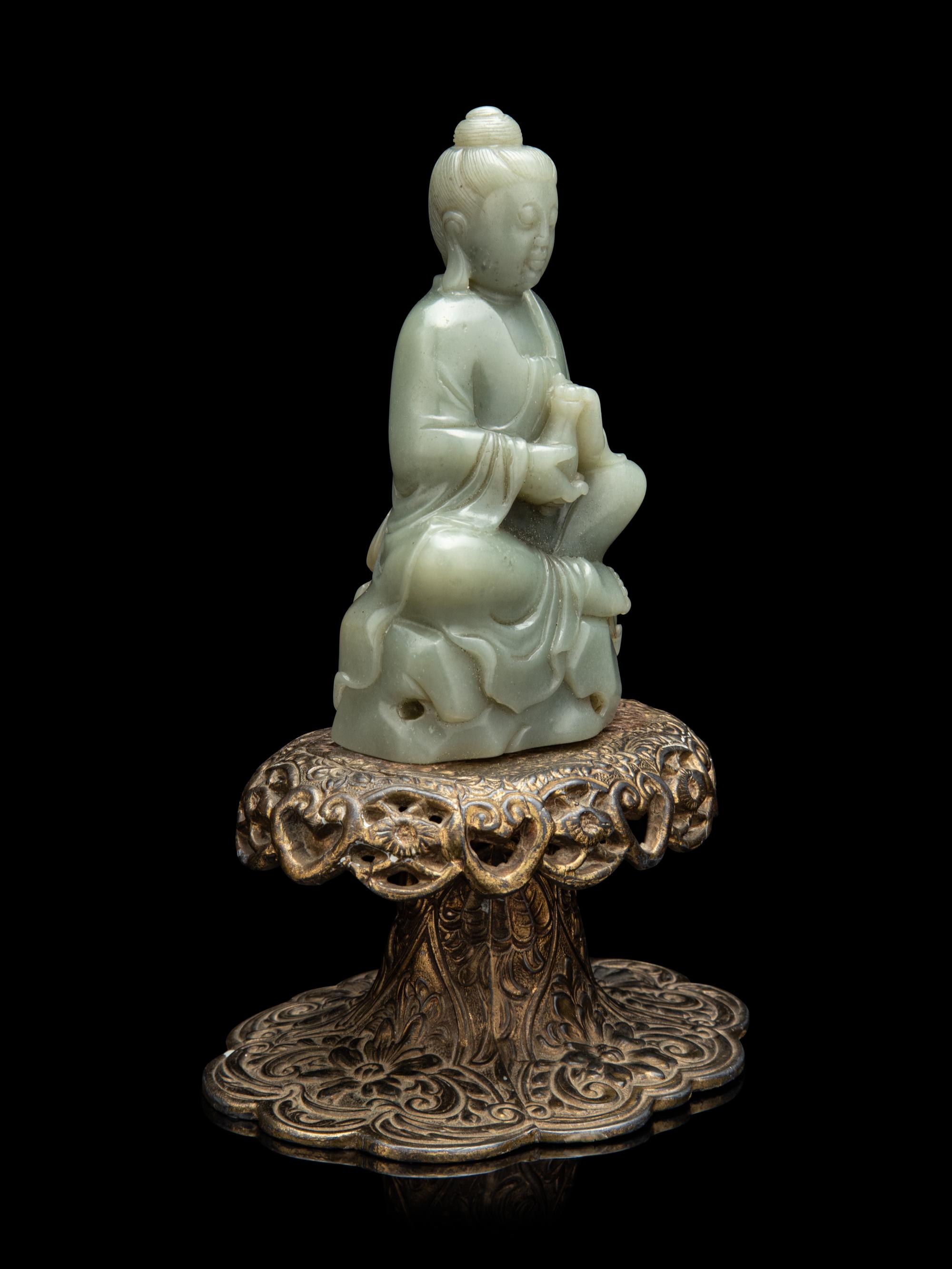 A Chinese Celadon Jade Figure of Seated Guanyin