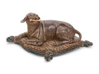 An Italian Carved and Painted Model of a Recumbent Dog