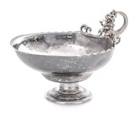 A German Silver Bonbon Dish, Maker's Mark M with a Lion Head, the Merlion handle above the rim having openwork volute and beaded decora