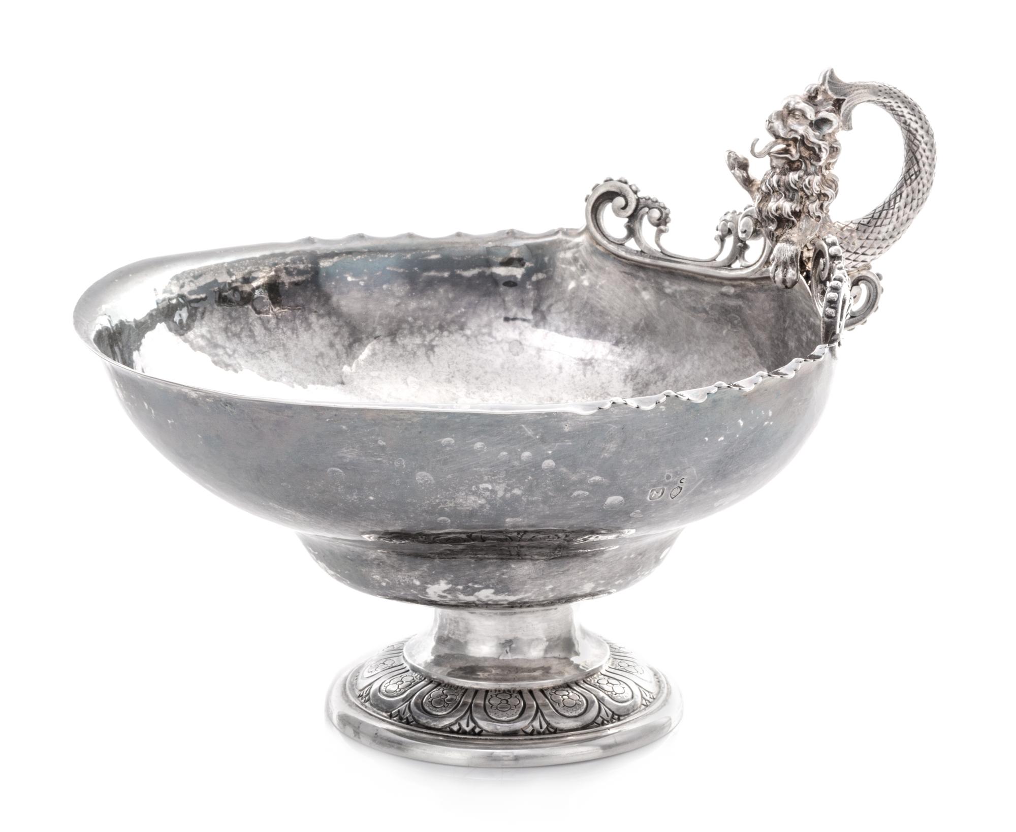 A German Silver Bonbon Dish, Maker's Mark M with a Lion Head, the Merlion handle above the rim having openwork volute and beaded decora