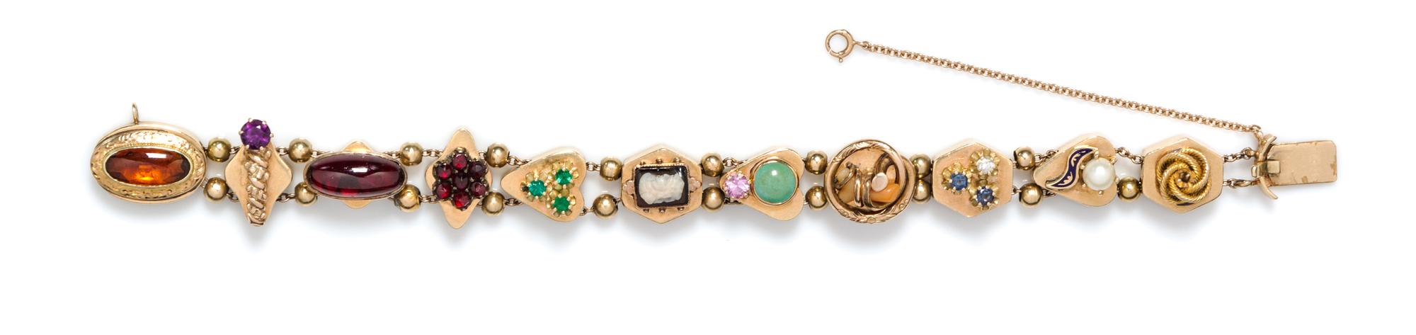 A Vintage 14 Karat Yellow Gold and Multi Gem Charm Slide Bracelet, 22.30 dwts.