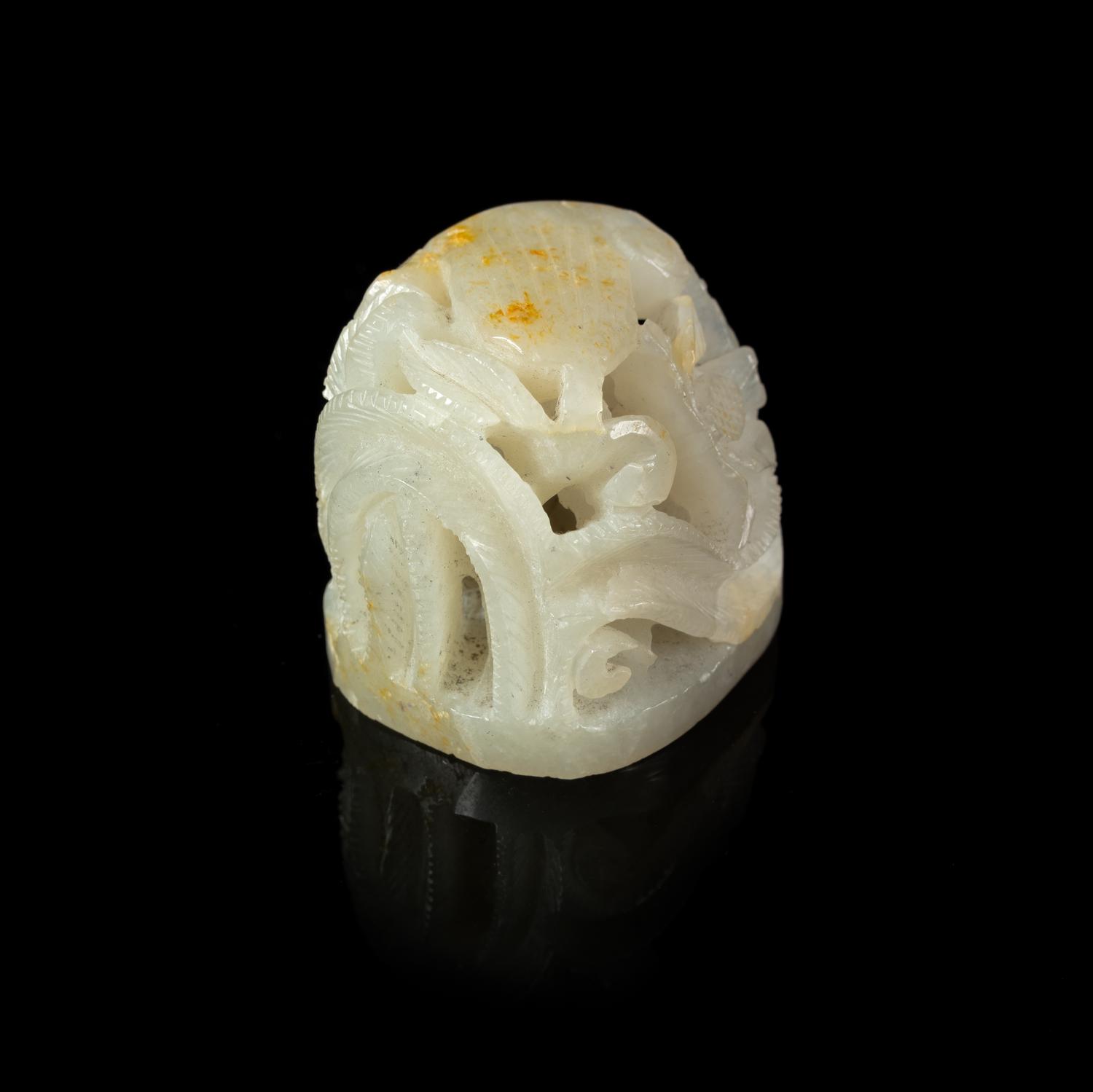A Carved Russet and White Jade Hat Finial
