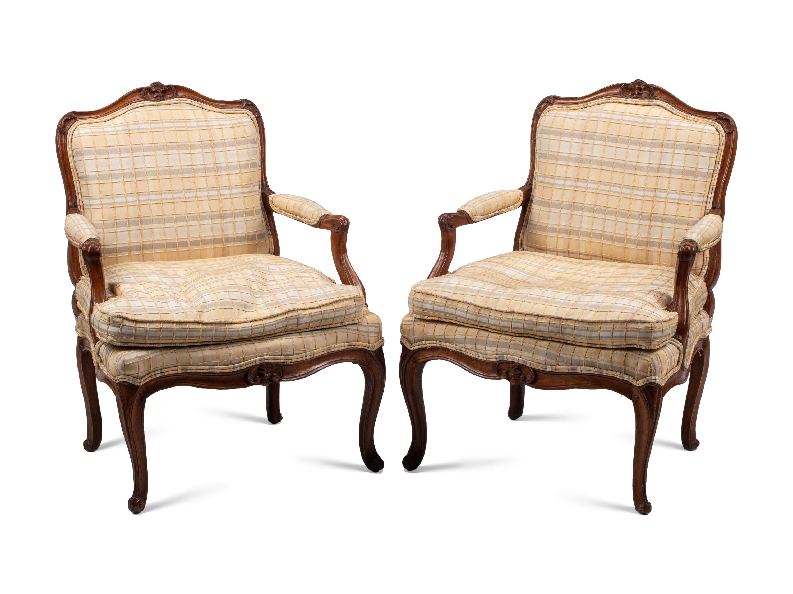 A Pair of Louis XV Provincial Walnut Fauteuils