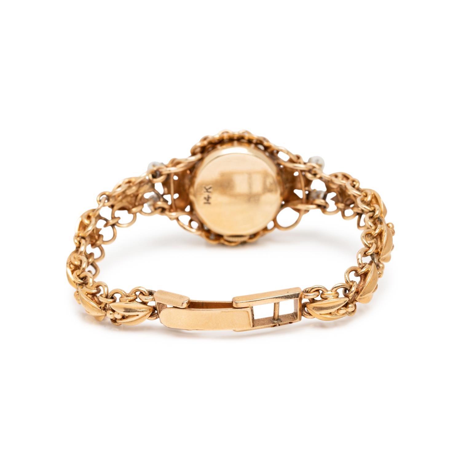 BIRKS, YELLOW GOLD AND CULTURED PEARL SURPRISE WATCH