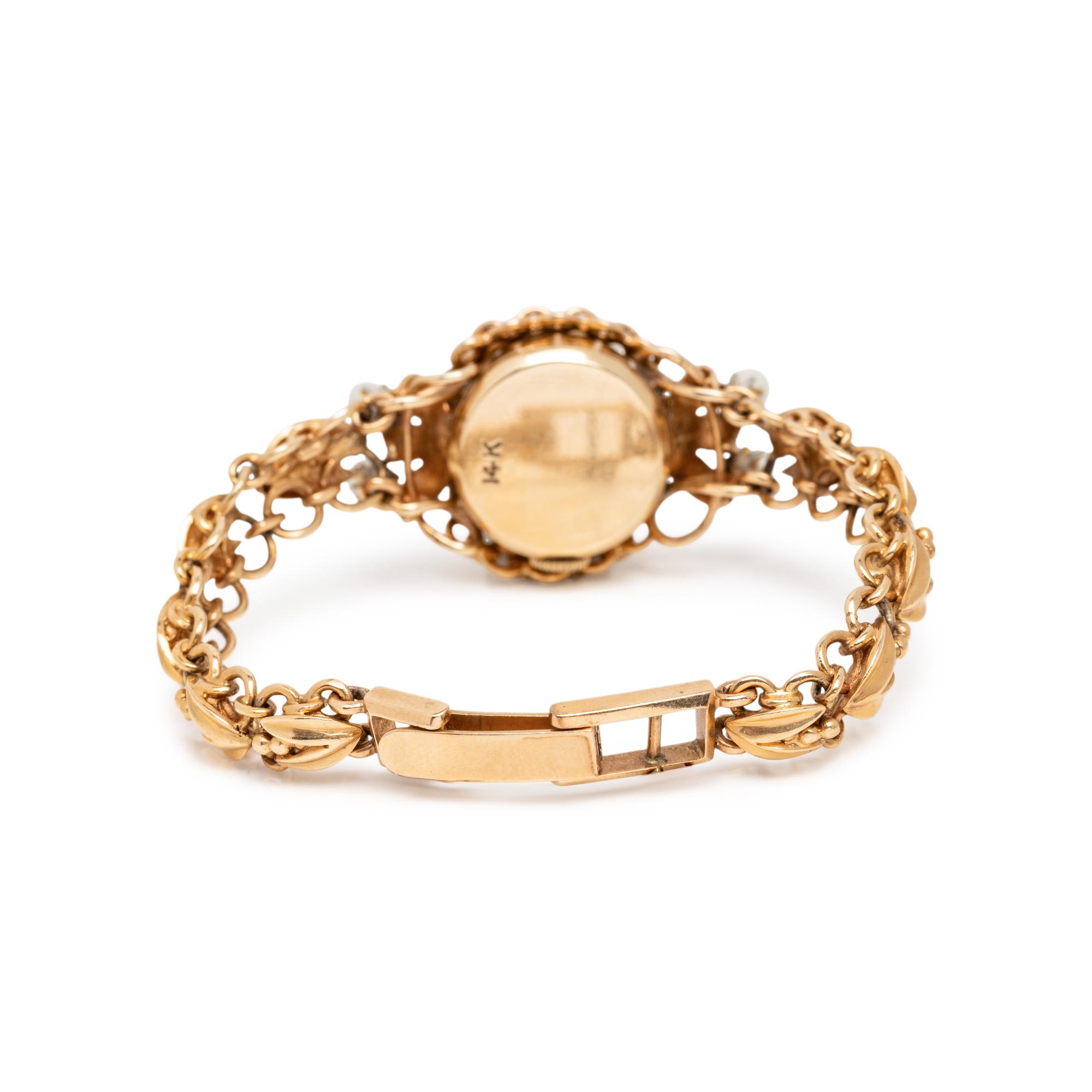 BIRKS, YELLOW GOLD AND CULTURED PEARL SURPRISE WATCH